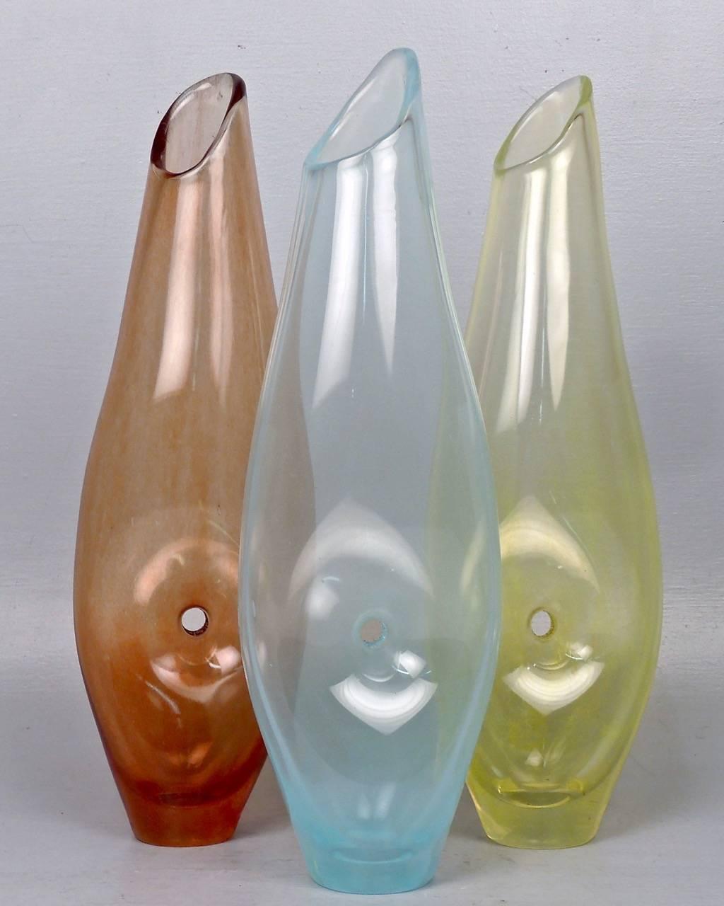 These vases comprise a set of three complimentary, organic, modernist vases by the noted Brazilian artist and designer Jacqueline Terpins. 

Each vase has a pierced center and an light, almost striated color distribution. The pierced center design