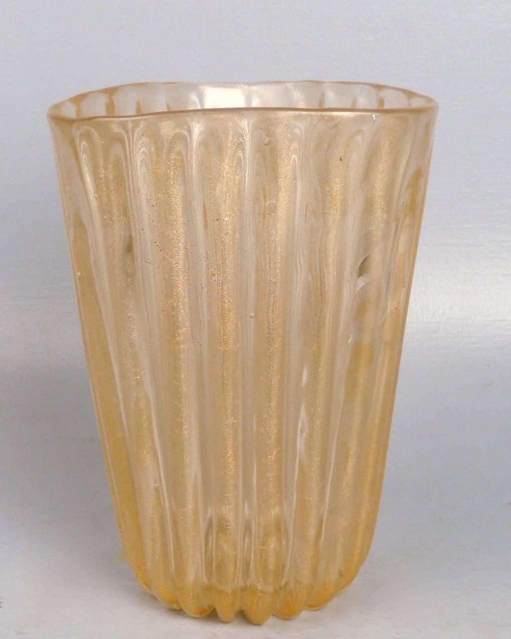 This thickly walled, ribbed vase designed by Archimede Seguso has gold fleck or foil inclusions and is labeled twice. This sturdy vase is organically modeled with a triangular mouth and straight tapered walls. A fine example of Mid-Century Italian