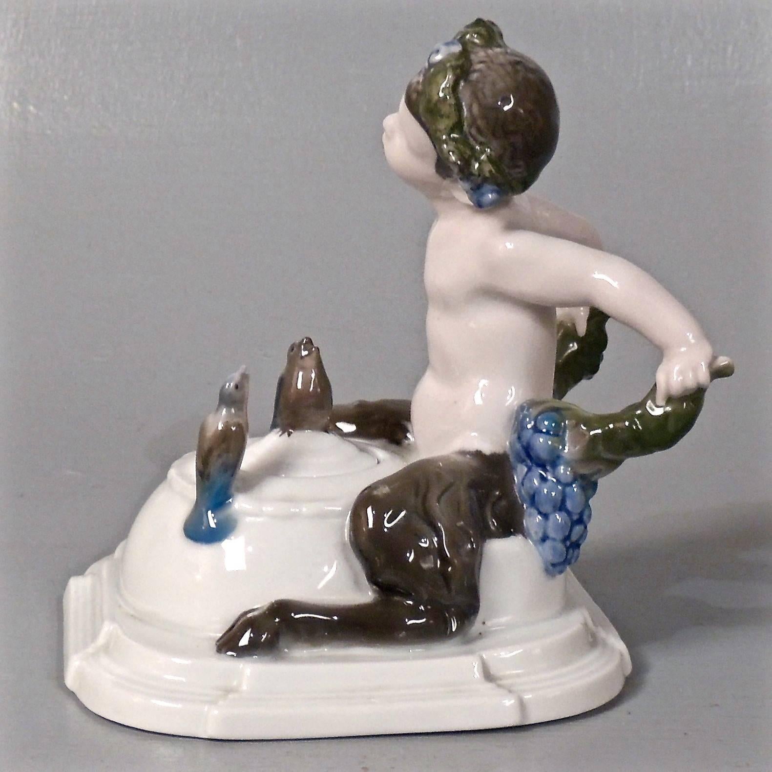 A rare figural Rosenthal porcelain inkwell entitled Symphonie.

The inkwell is modeled in the form of a young faun sitting astride the inkwell body and bending his ear to listen the symphony of the songbirds, which are perched atop both the lid