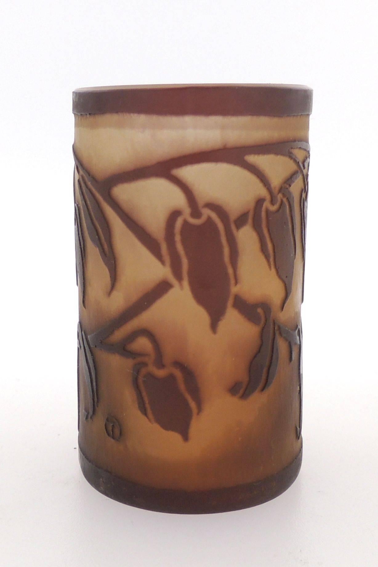Designed by Otto Tauschek for Karl Ludwig Moser, this small beaker shaped glass vase is deeply etched with stylized twigs with flowers and leaves. It has strong Jugendstil form. The front bears etched OT in circle mark for Otto Tauschek and LKM in