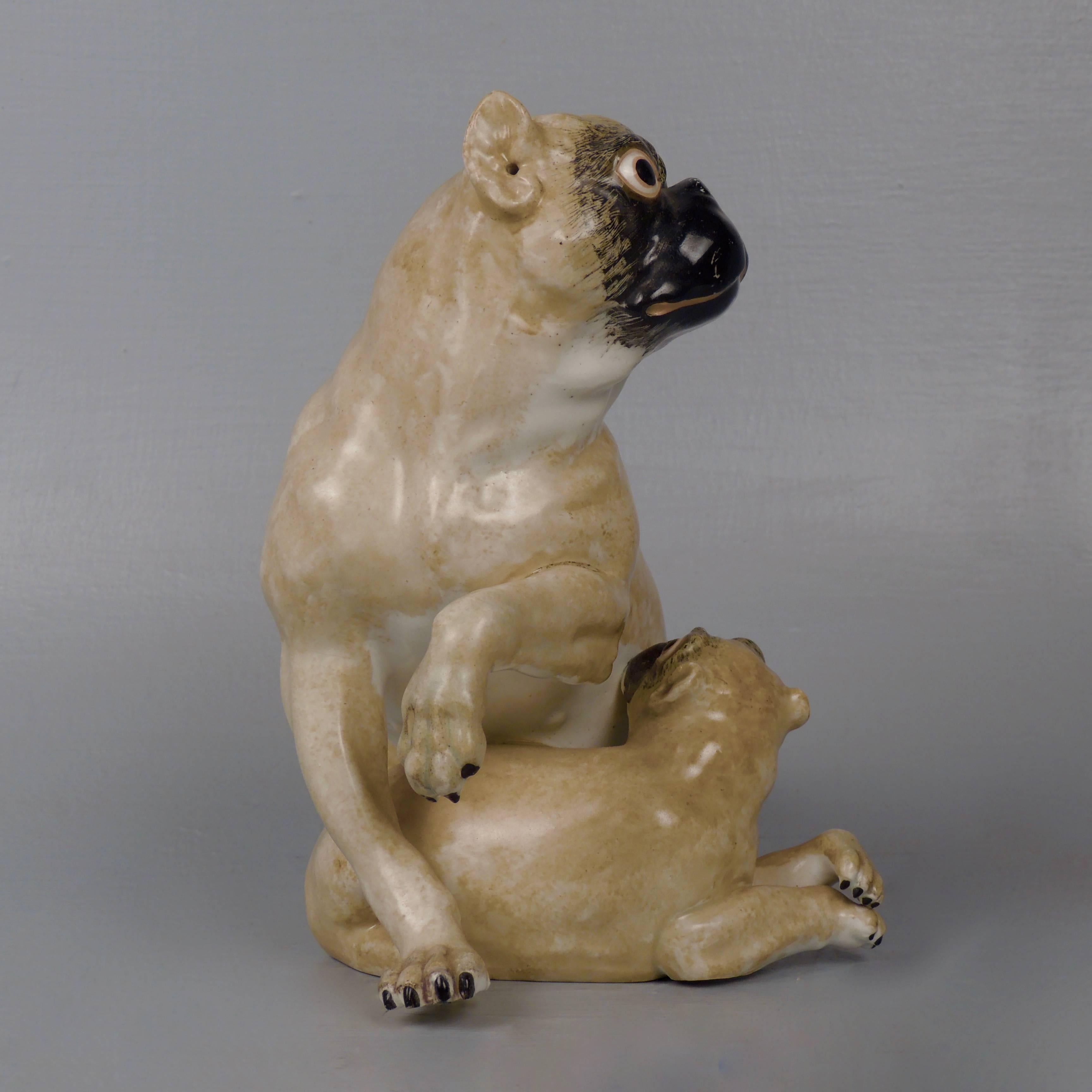 A rare, early 19th century English hard-paste porcelain pug & puppy figurine. 

These early English figurines are all modeled after the Meissen factory's first Pug model by J. Kaendler (in an attempt to reproduce his fashionable style that had taken