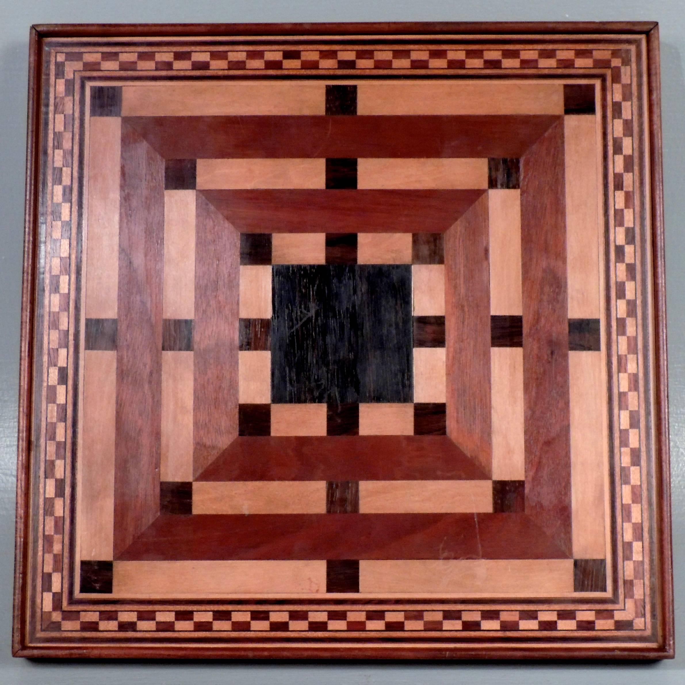 This is a fine handmade inlaid wooden game board. The front is for checkers and chess. They reverse is a starburst pattern and is probably for some variant of parcheesi. Made of mahogany, ebony, rosewood, and satinwood. Dates to the early to