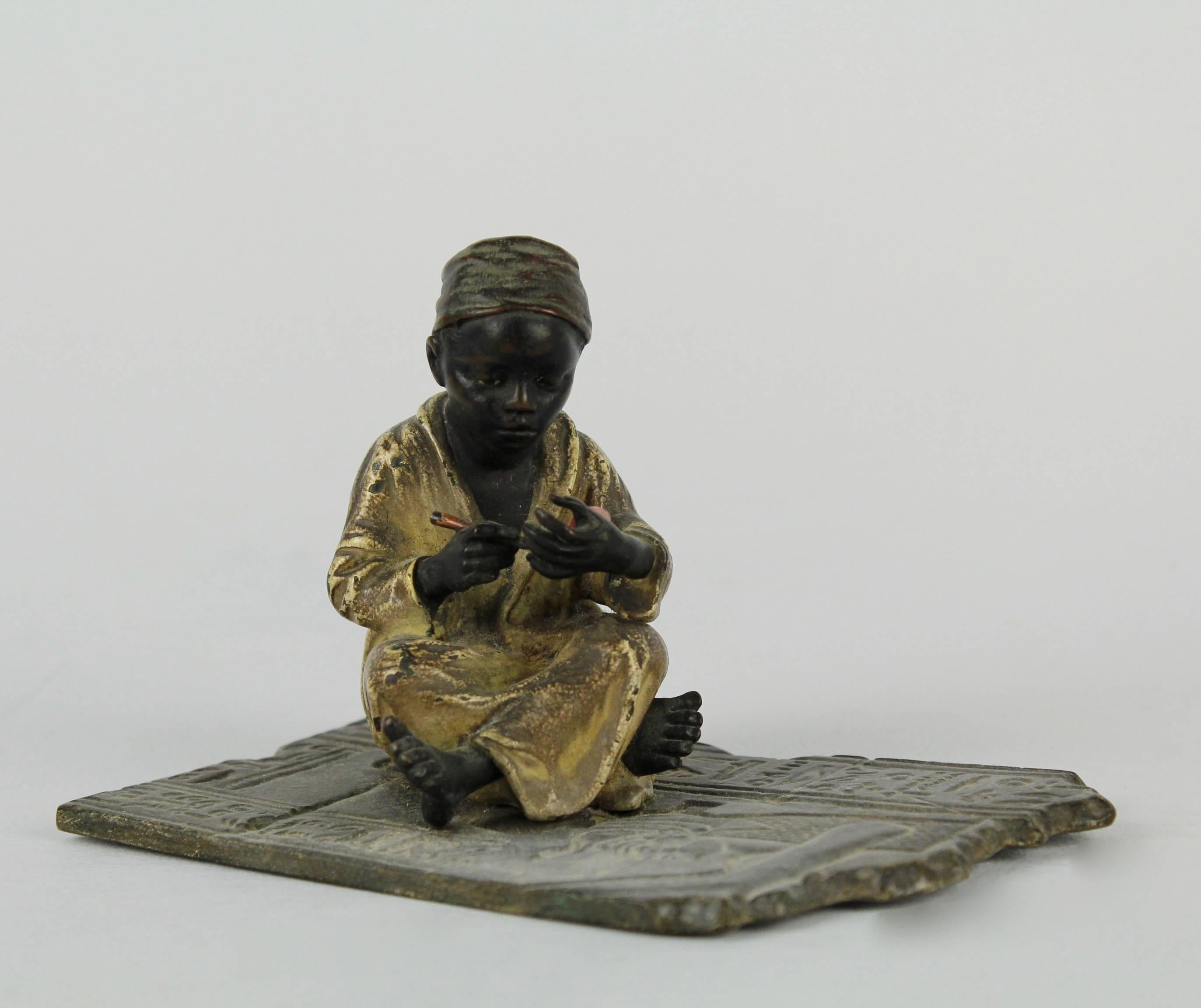 Islamic Cold Painted Orientalist Bronze Sculpture of a Seated Arab Boy by F. Bergmann