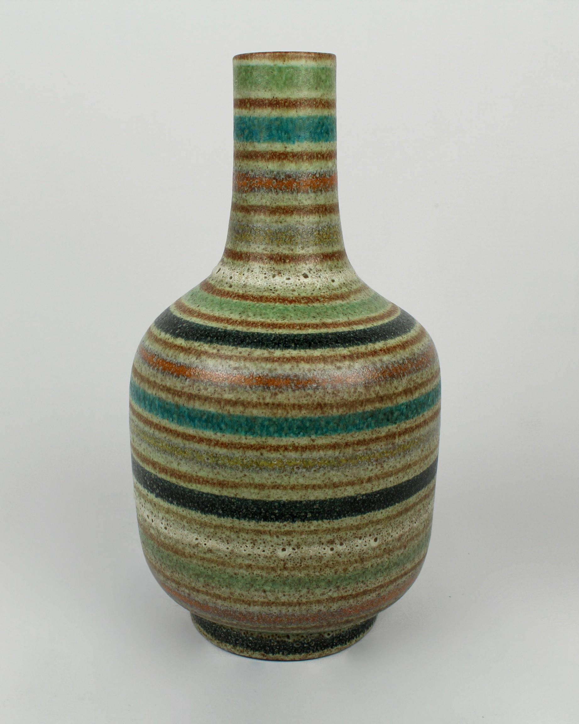A fine and robustly glazed Mid-Century Modern Italian art pottery vase in the style of Gambone or Bistossi. The textured surface shows openings in the thick glaze and is decorated with alternating horizontal stripes. The base is marked with a script
