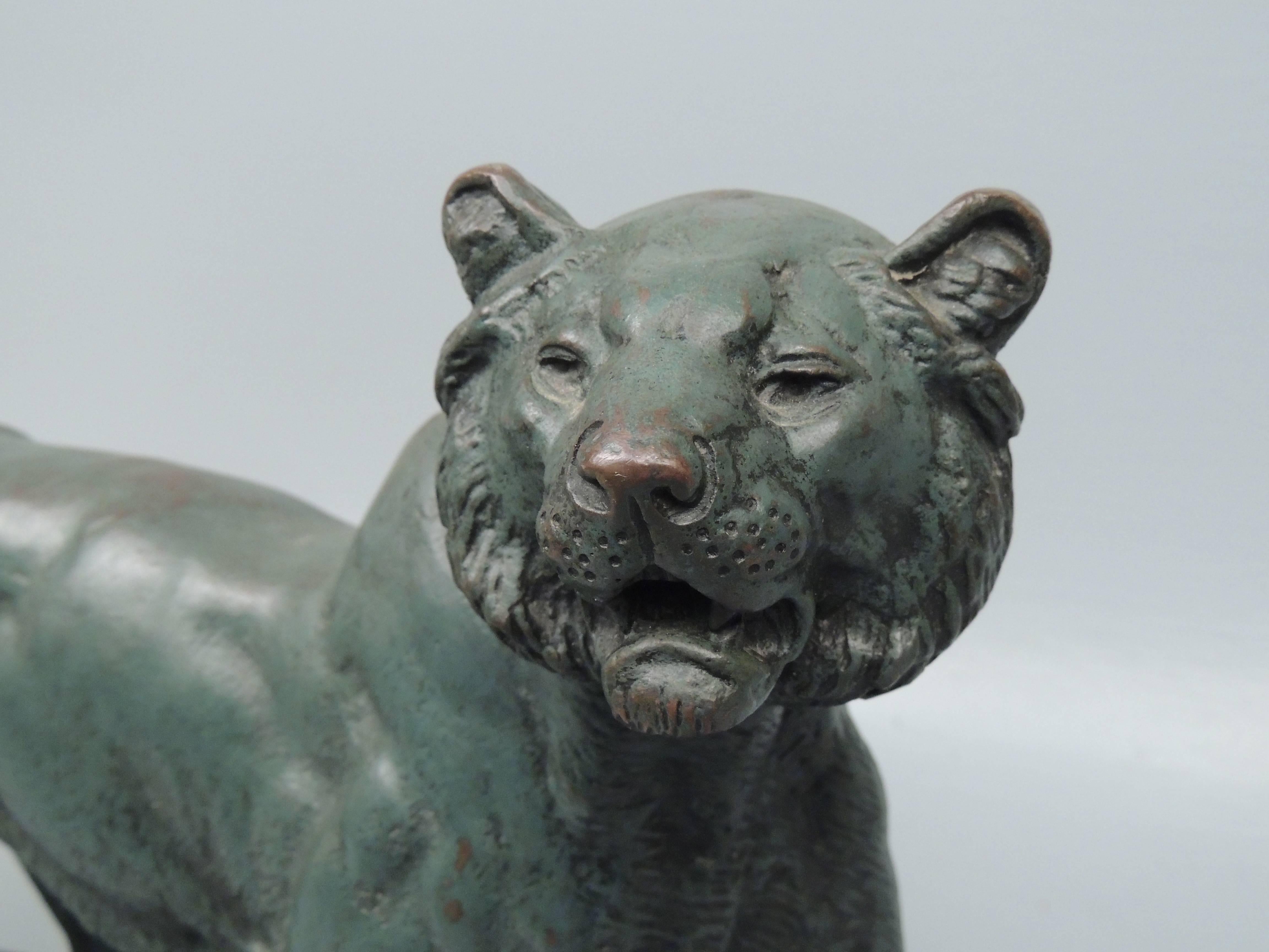 A large bronze sculpture of a lion after Paul Edourard Delabrierre with a verdigris patina.

Delabrierre, Paul Edouard (1829-1912).
Born in Paris in 1829, he made his debut at the Salon 1948. He exhibited there regularly until 1882. He was an