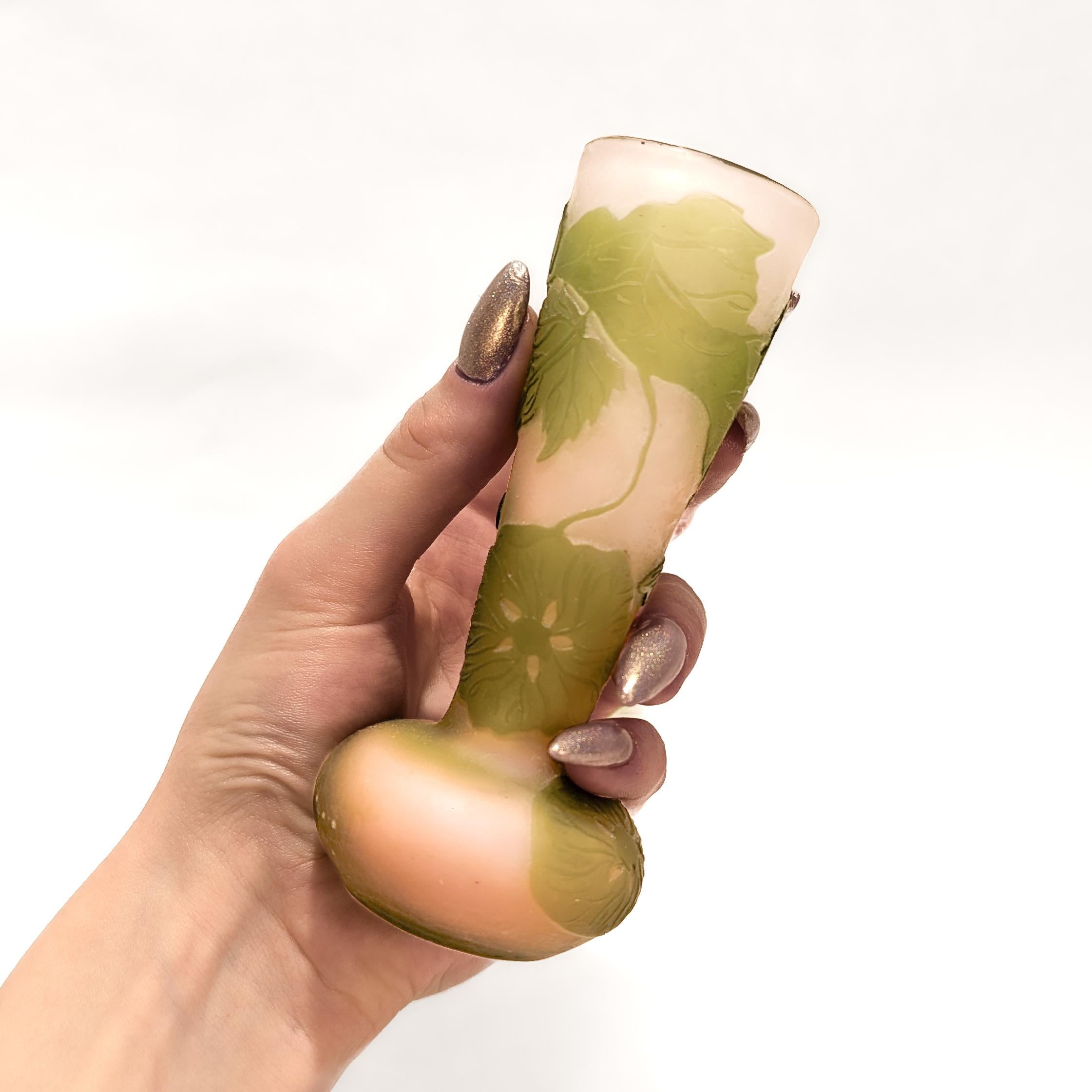 A fine antique cabinet-sized French art glass vase.

By Gallé.

With a bulbous base and a conical body.

In light pink with acid-cut back cameo of flowers and foliage in green .

Signed 