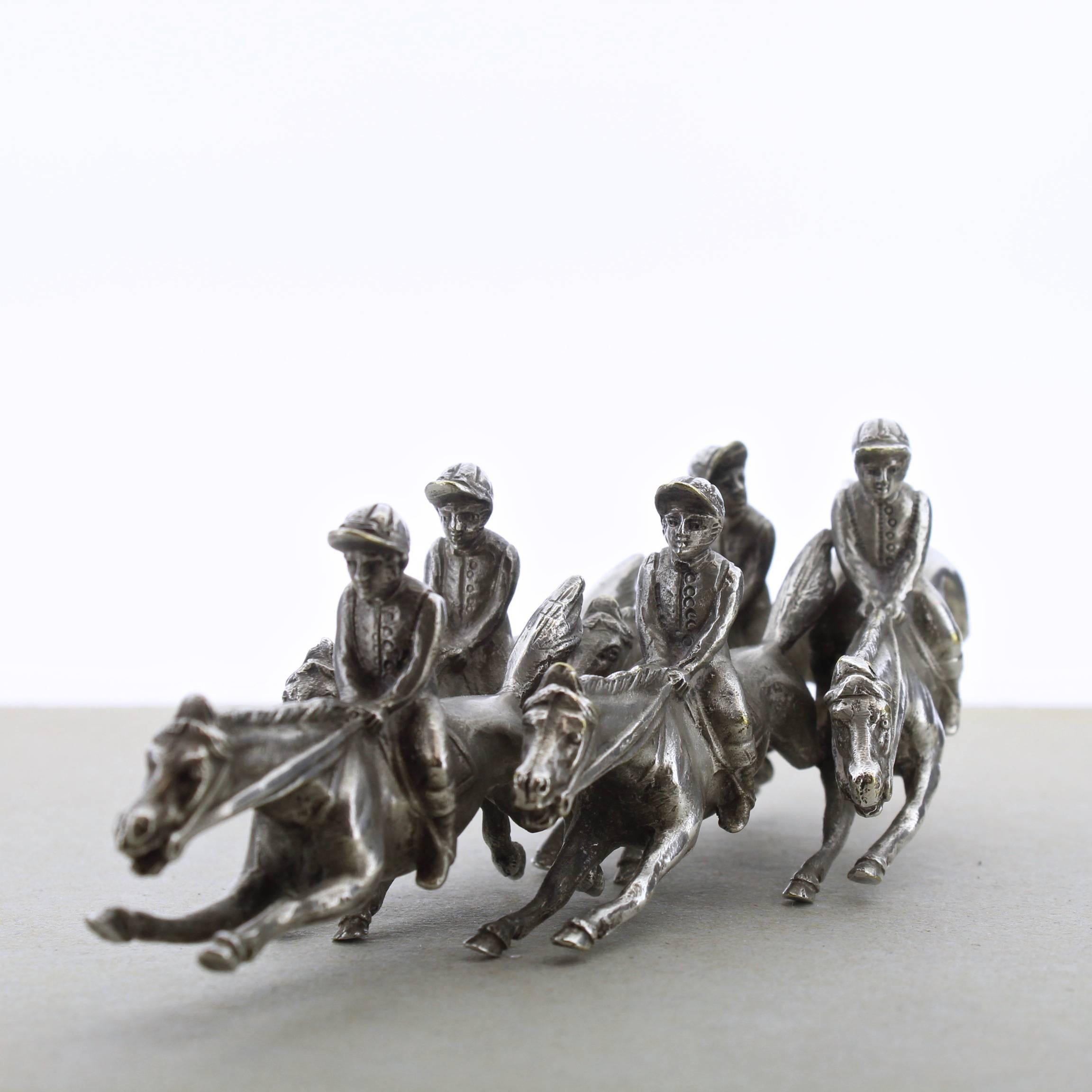 A terrific, vintage silverplate miniature figural group of horses and jockeys in full throated gallop. 

A paperweight-sized sculpture with wonderful modeling and detail throughout. 

Length: ca. 6 in.

Items purchased from David Sterner
