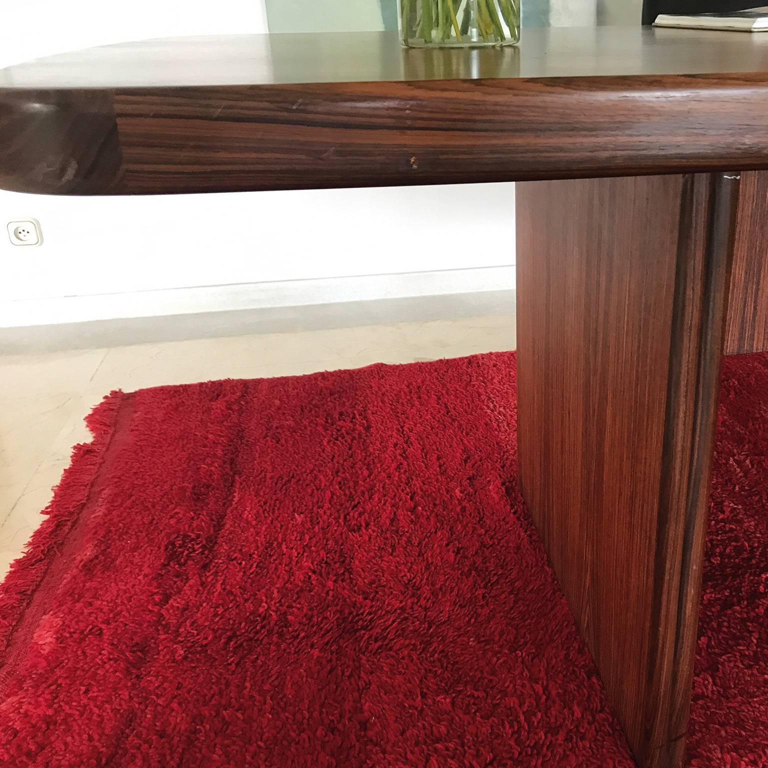 This piece is an elegant rosewood desk designed in 1970s and attributed to Carlos Casablanques, Spanish architect.