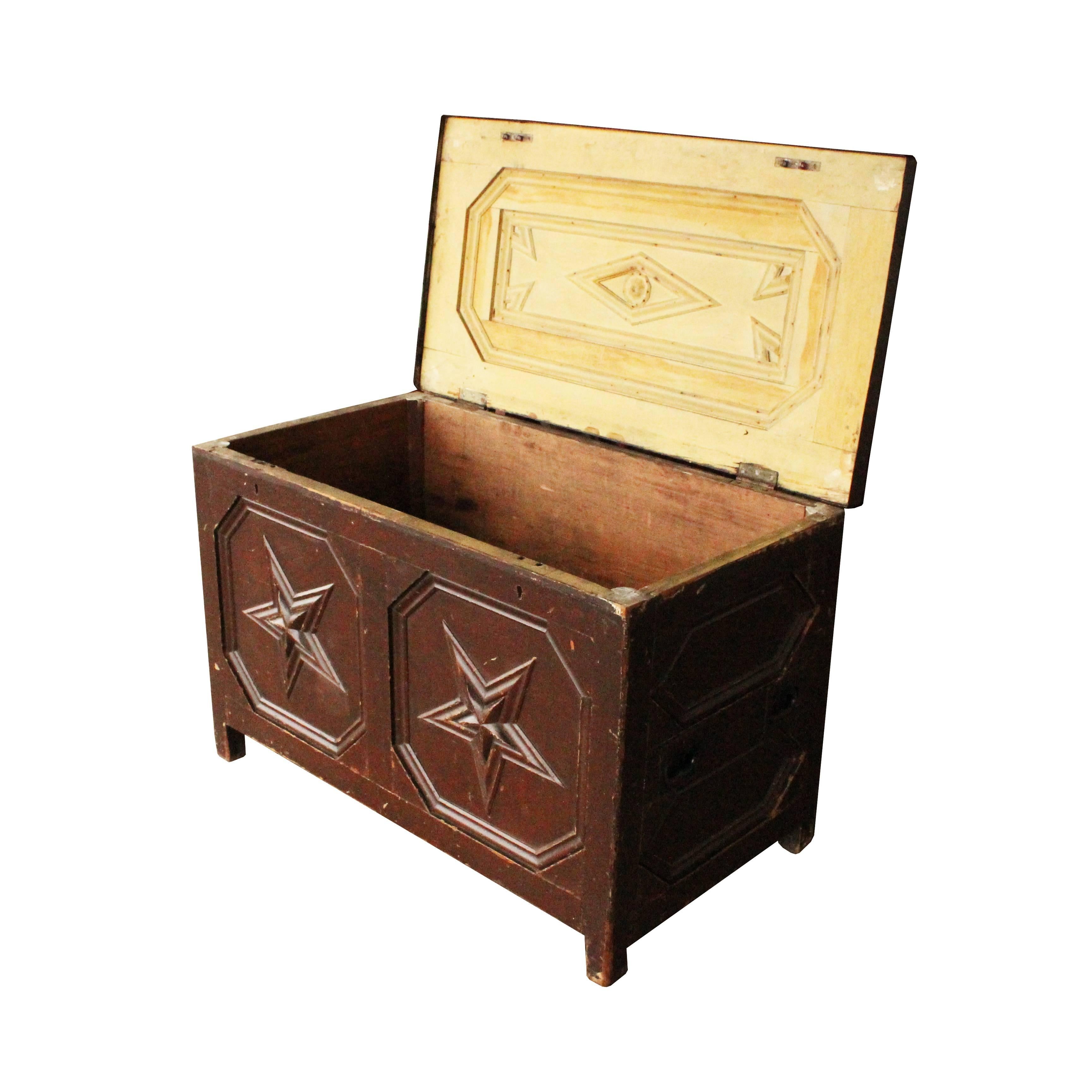 A late 19th century American Folk Art trunk with plenty of handmade details. Recessed paneling covers the inside and outside of this piece that features stars, florets and diamonds.