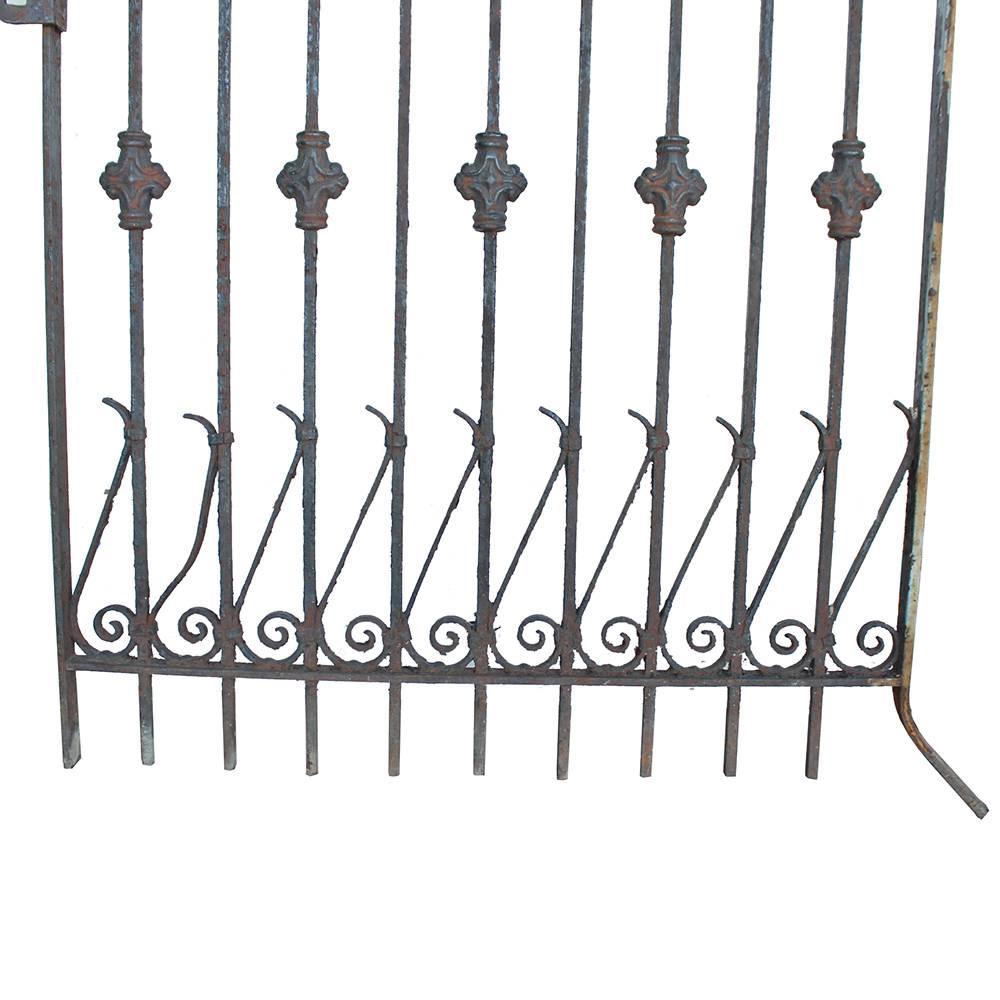A balancing act of arrows, curlicues, and medallions adorn this wrought iron gate with cast details. Perfect late Victorian style with an unusual 77