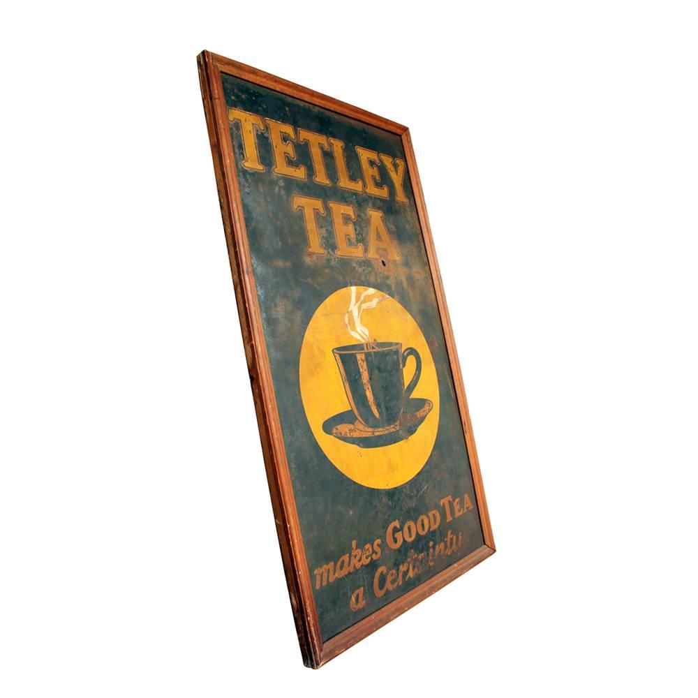 Great early 20th century advertising. This, circa 1920 Tetley brand tea sign is made of sheet steel in a wood frame with a cloth backing. The sign is in fair shape with some wear and loss, but overall still shows great color and detail in the