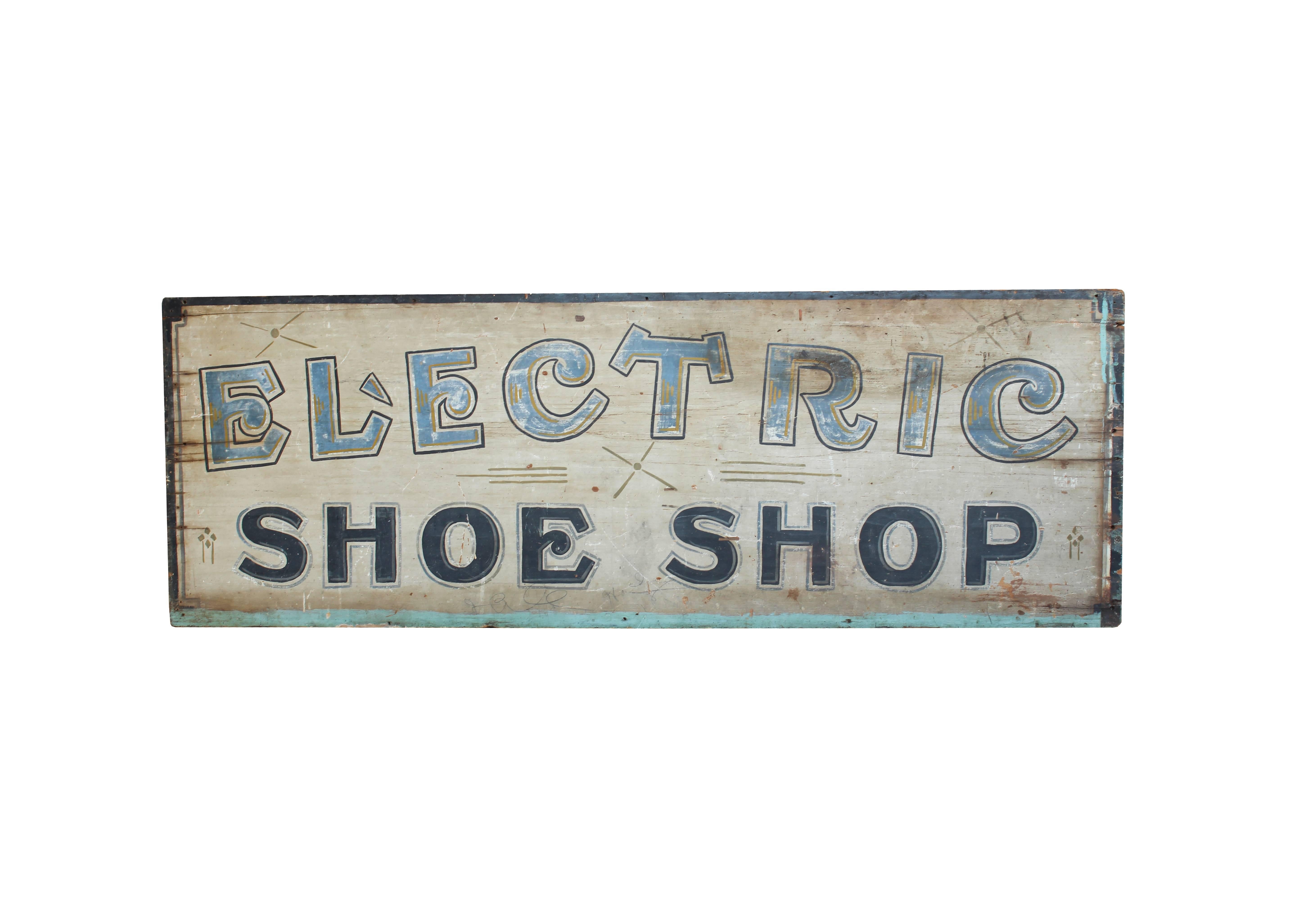 This very early 20th century wood sign is hand-painted and double sided. With a bold font in keeping with Classic turn-of-the-century styles, the pale blue, navy, green, and gold colors are still vibrant. The slight variations in the green accents