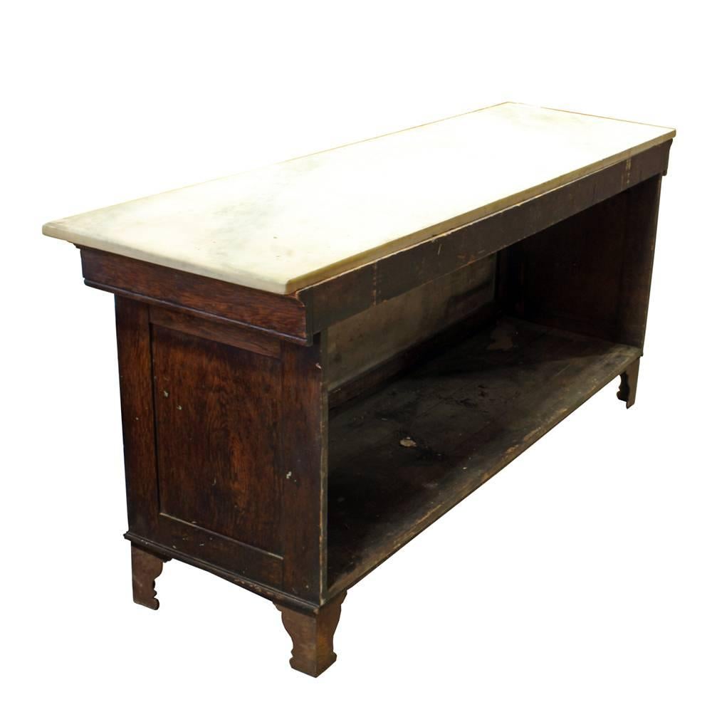 The Bernard Gloekler Company was founded in Pittsburgh, PA in the late 19th century and had a thriving business manufacturing butcher and grocer’s equipment and supplies. This solid oak marble topped case has an opalite glass front panel and