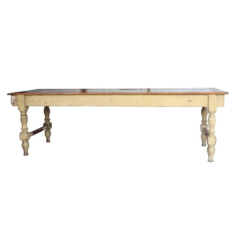 This beautiful rustic farm table has character in leaps and bounds. Beautifully turned legs with a great weathered paint job in a shade of ochre compliments the deep rich hues of the stained tabletop. A few grooves and a knot hole or two add to the