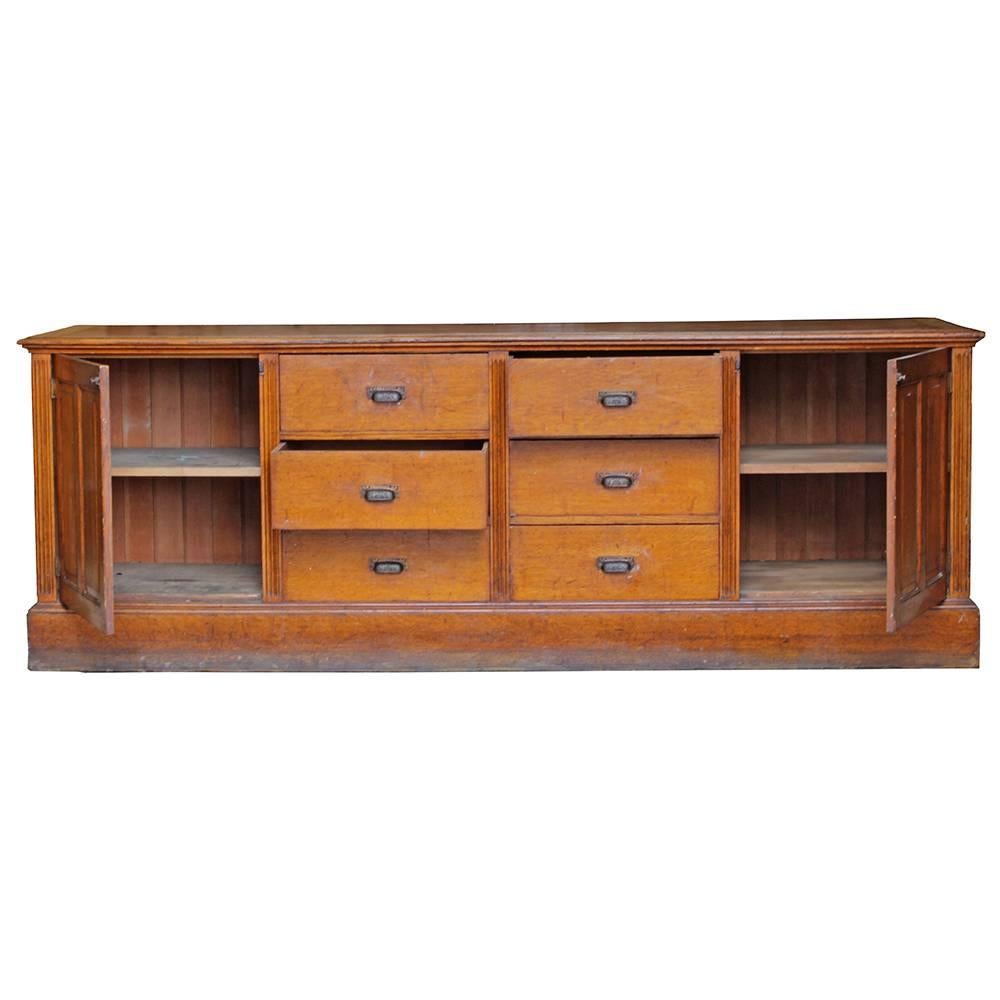 This absolutely beautiful late 19th century storage counter once graced the floor jeweler’s shop in San Francisco. The well crafted construction and ornate hardware really shine on this piece. Plenty of space in the six drawers and shelved cabinets