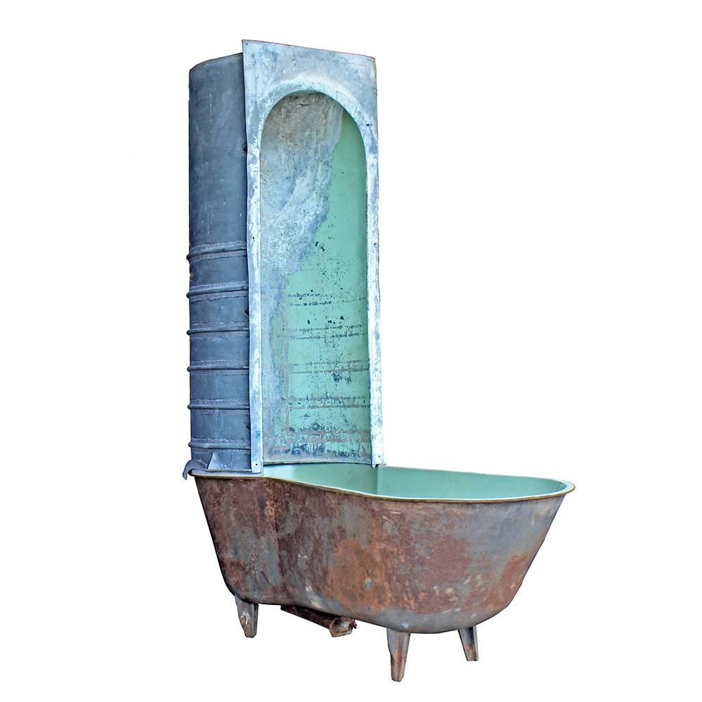 This rustic piece really sings in its weathered state. An early 20th century French piece, the zinc shower surround retains some of its original plumbing pipes, with a shower head that was made by simply poking a network of holes into the top of the