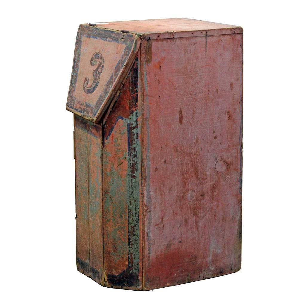Salvaged from a building in New York that had been a coffee roasting facility in the early 20th century, this hand-painted bin has a beautiful Primitive/folk aesthetic. The four-panel beveled front complements the hinged lid, painted with the number