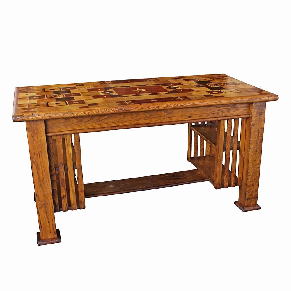 Testing the limits of the term “Folk Art”, this unassuming Arts and Crafts styled oak desk has a top that is a work of art; exhibiting some of the loveliest wood marquetry work we have seen in our shop. The top's layout and design is inspired and