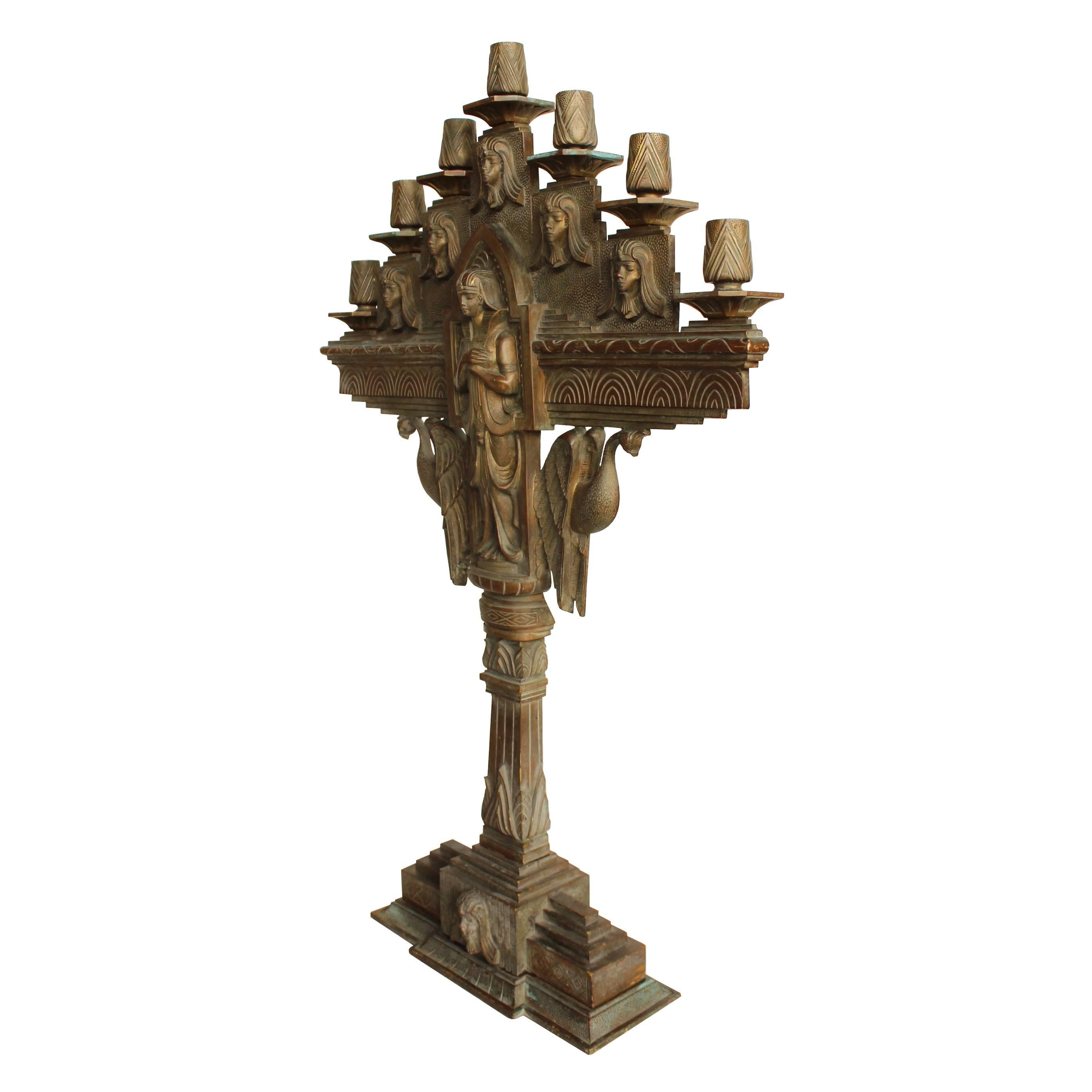 This early 20th century bronze candelabrum has all the drama and mystique of an excellent Egyptian Revival piece. Geometric designs in concentric patterns accentuate fantastic stylized Pharaoh figures.  May have been used in a fraternal lodge.