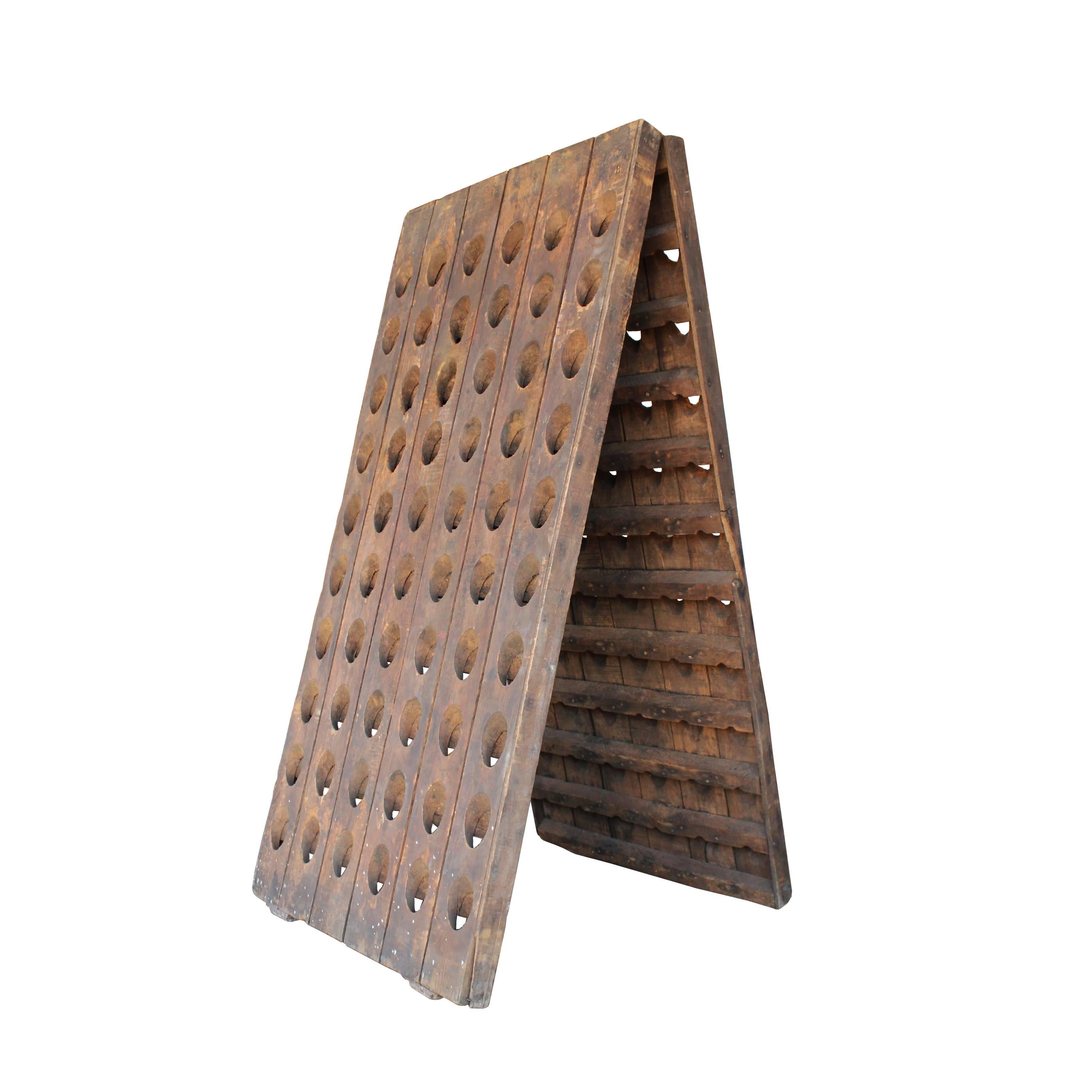 Used in the production of champagne to aid in the removal of sediment and yeast from the fermentation process, the riddling rack has long been an indispensable tool to vintners. This A-frame style hardwood rack has space for 120 bottles.