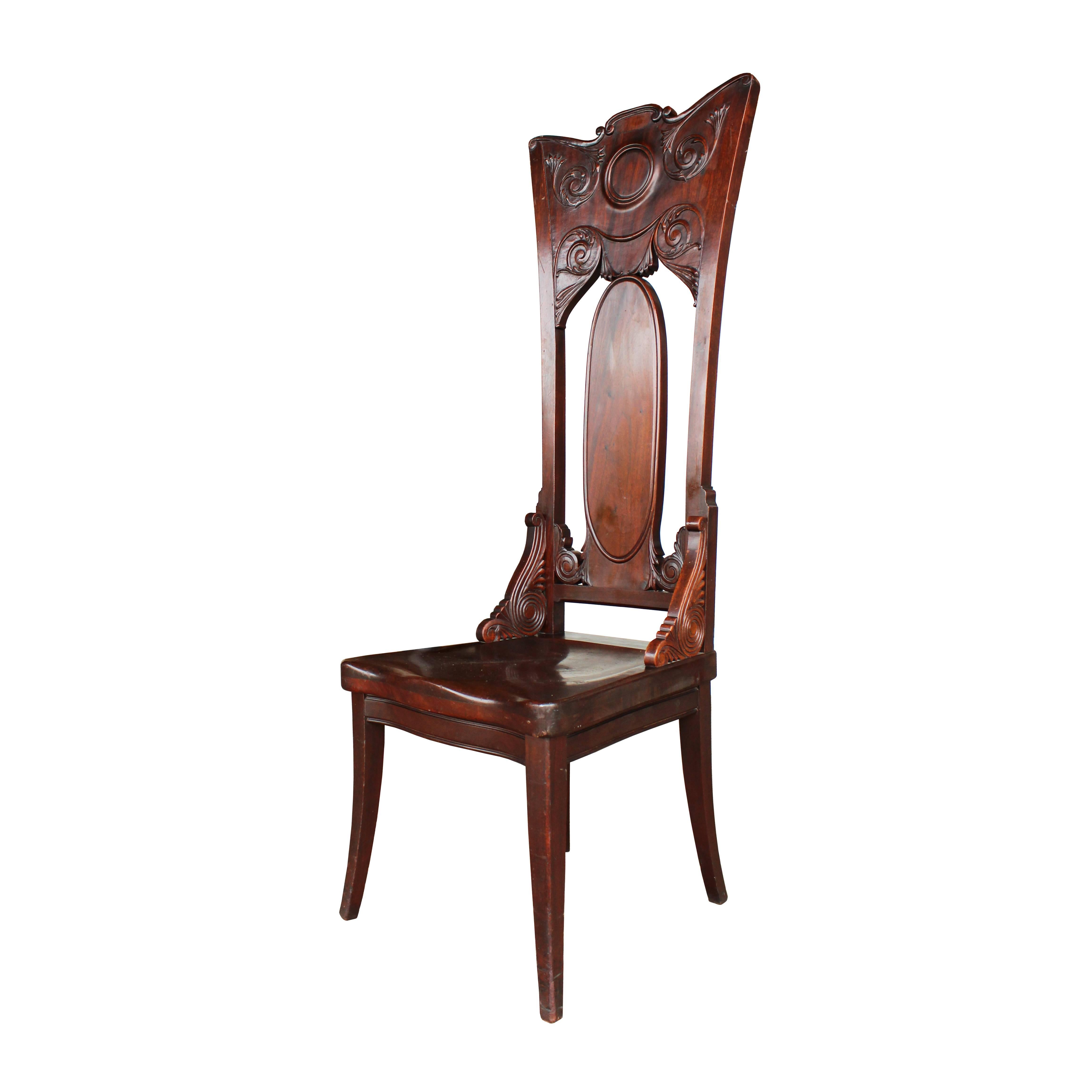 These chairs have a presence all their own with floriated scroll work carving and whimsically curved backs bringing Victorian charm and Art Nouveau fluidly together. Open backs are perforated with a central ovoid back slat and are connected to a