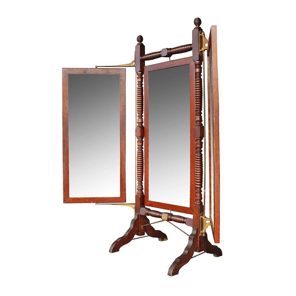 This triplicate folding mirror was a patented design and utilized by clothiers and haberdashers alike. Manufactured in the late 19th century by the John B. Willard company, the mirror has a rich dark patina and turned details. This piece also