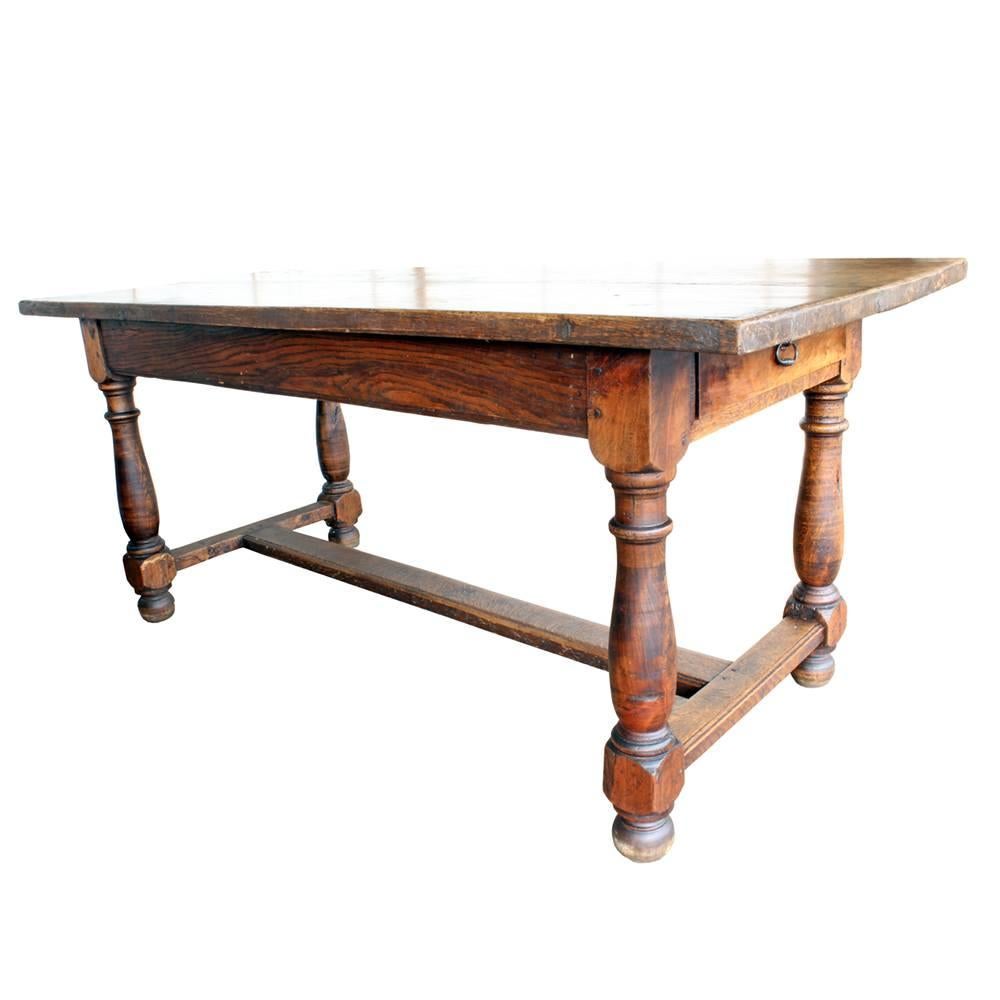 A beautiful and substantial solid oak table made in the early 20th century in France. The charming character of the top, which embraces the natural growth patterns of the wood, gives it just the right touch of rusticity. The Classic Silhouette and