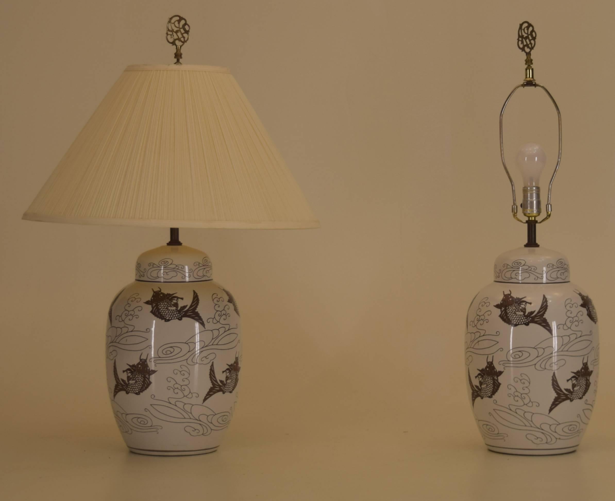 Young girls rinding upon carp or koi are the featured motif of these exceptional table lamps. Coupled with the finials and hi-gloss glaze they are bold and appealing.

The vessels are likely porcelain if not fired pottery.

The application of