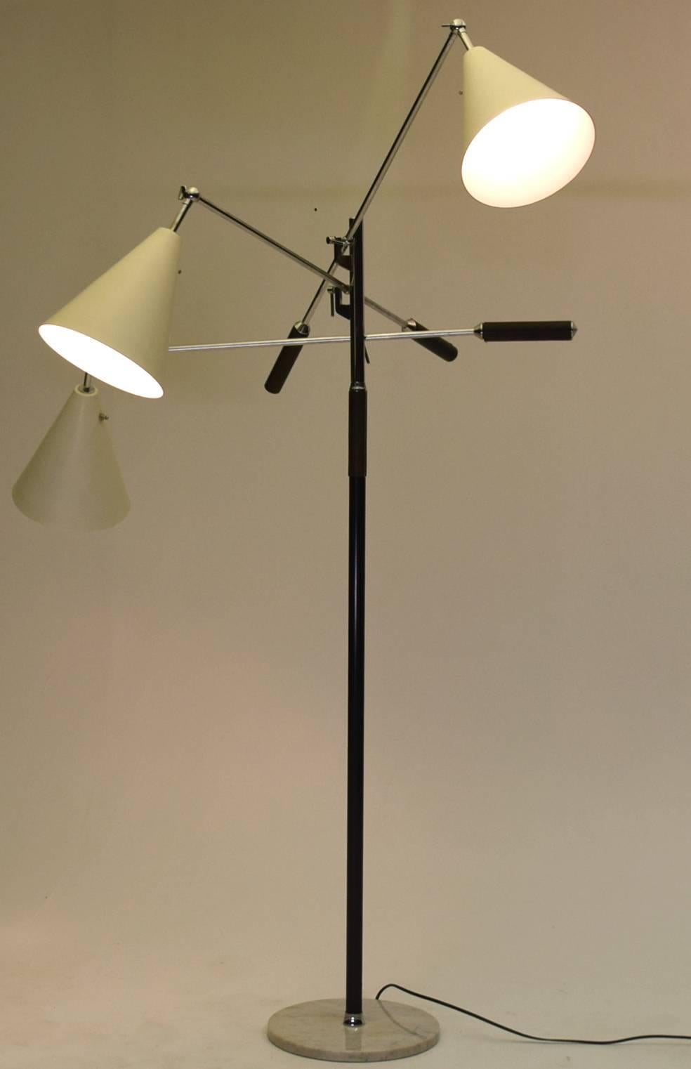 Three-arm floor lamp made in Italy. Stamped to base and stem. Iconic modern lighting with fully articulating arms.

Often referred to as the 
