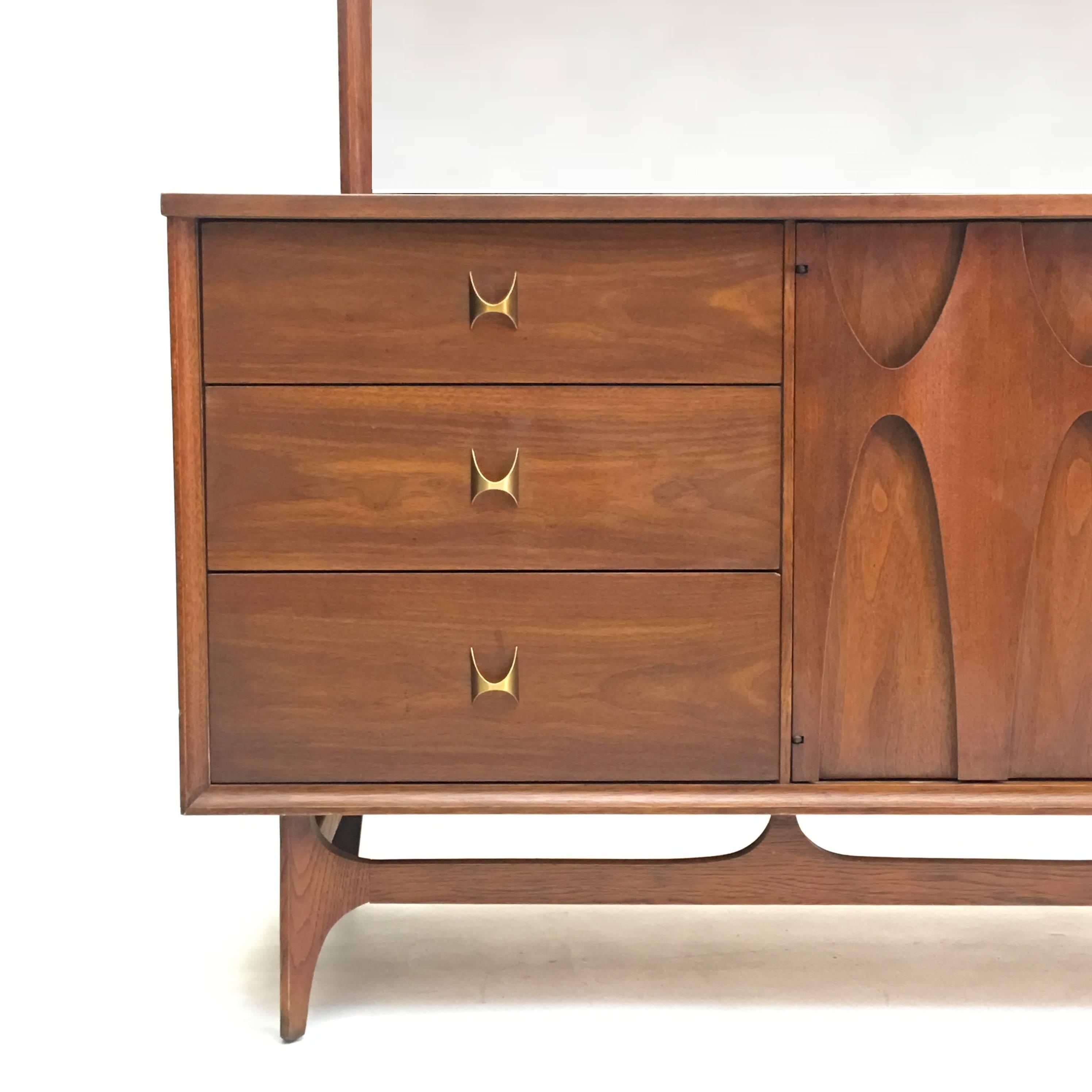 Lavish walnut coupled with brass accents make this triple dresser from Broyhill Brasilia Premier one of the finest dressers to be owned. Renown for the use of rich thick American walnut and solid construction, Broyhill Brasilia bedroom pieces are