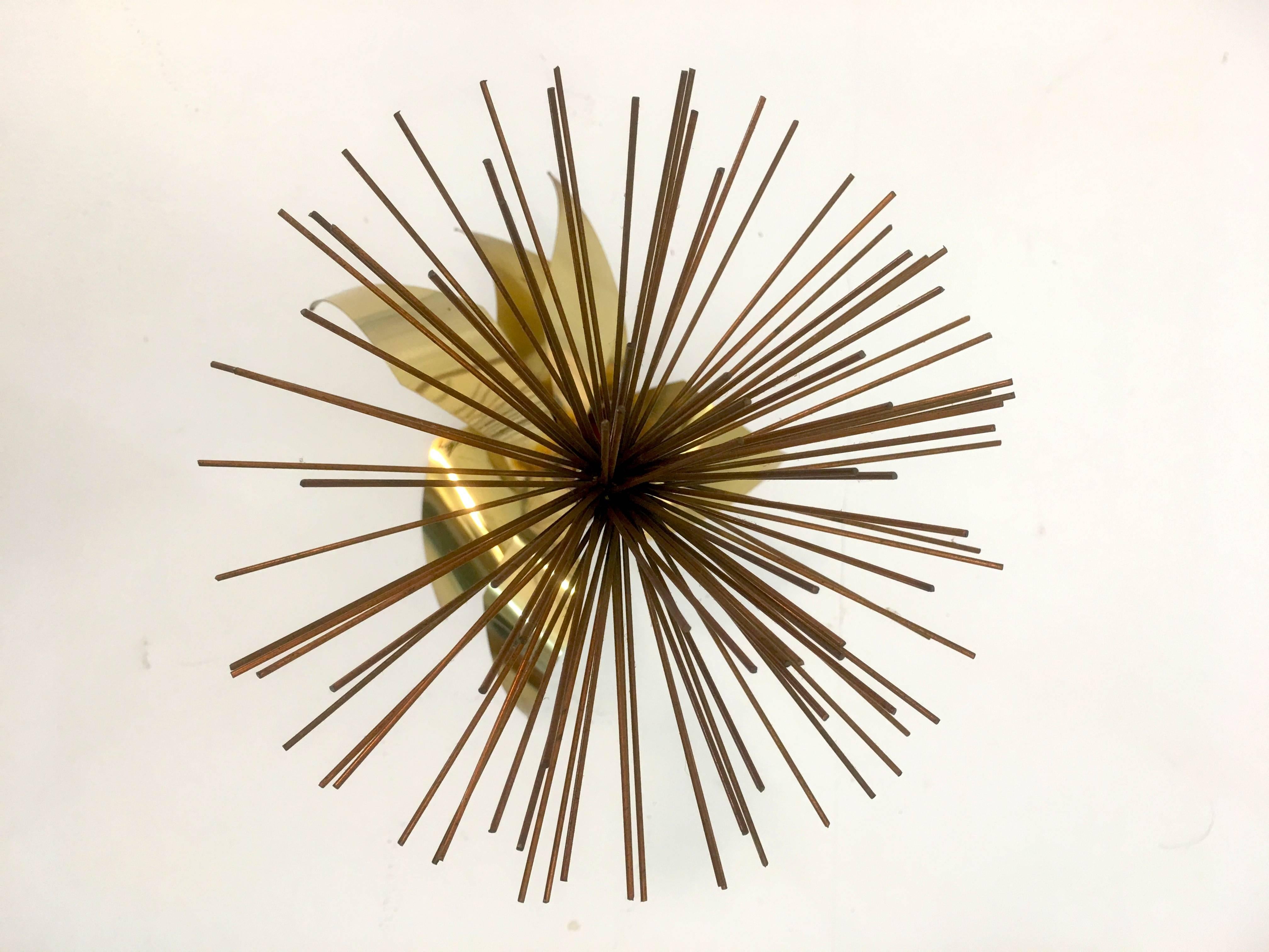 Signed but undated and likely produced 1979-1981, this sculpture by C. Jere is a mixed metal sculpture deploying copper, brass and steel to create what is sometimes referred to as also the pom pom or sea urchin style splayed element that was used in