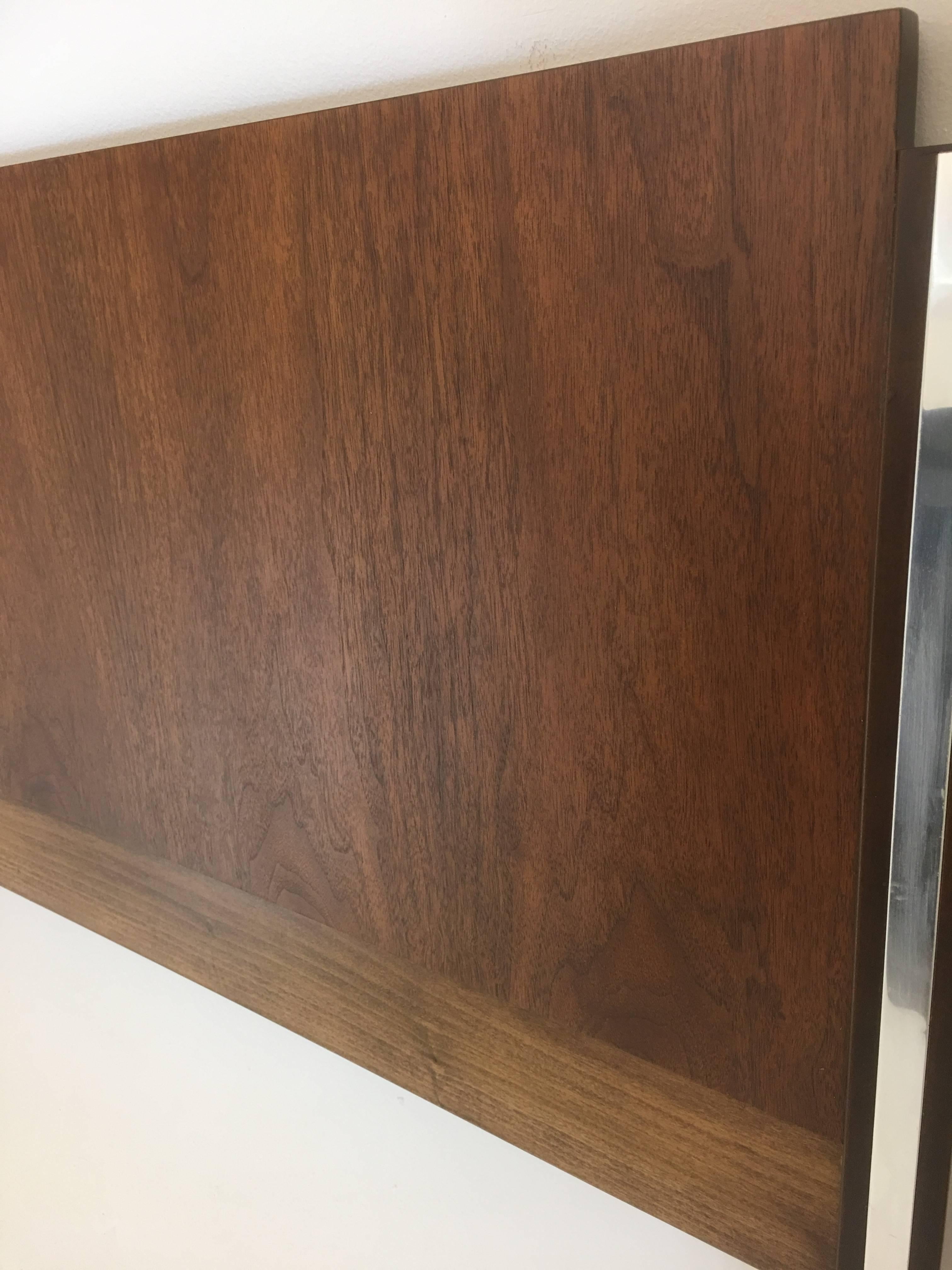 Produced in 1970 by Broyhill premier, this headboard is produced with walnut and chromed strips inserted into the frame. It is designed for a double sized mattress.

The entire front of the headboard has been refinished and the frame itself was
