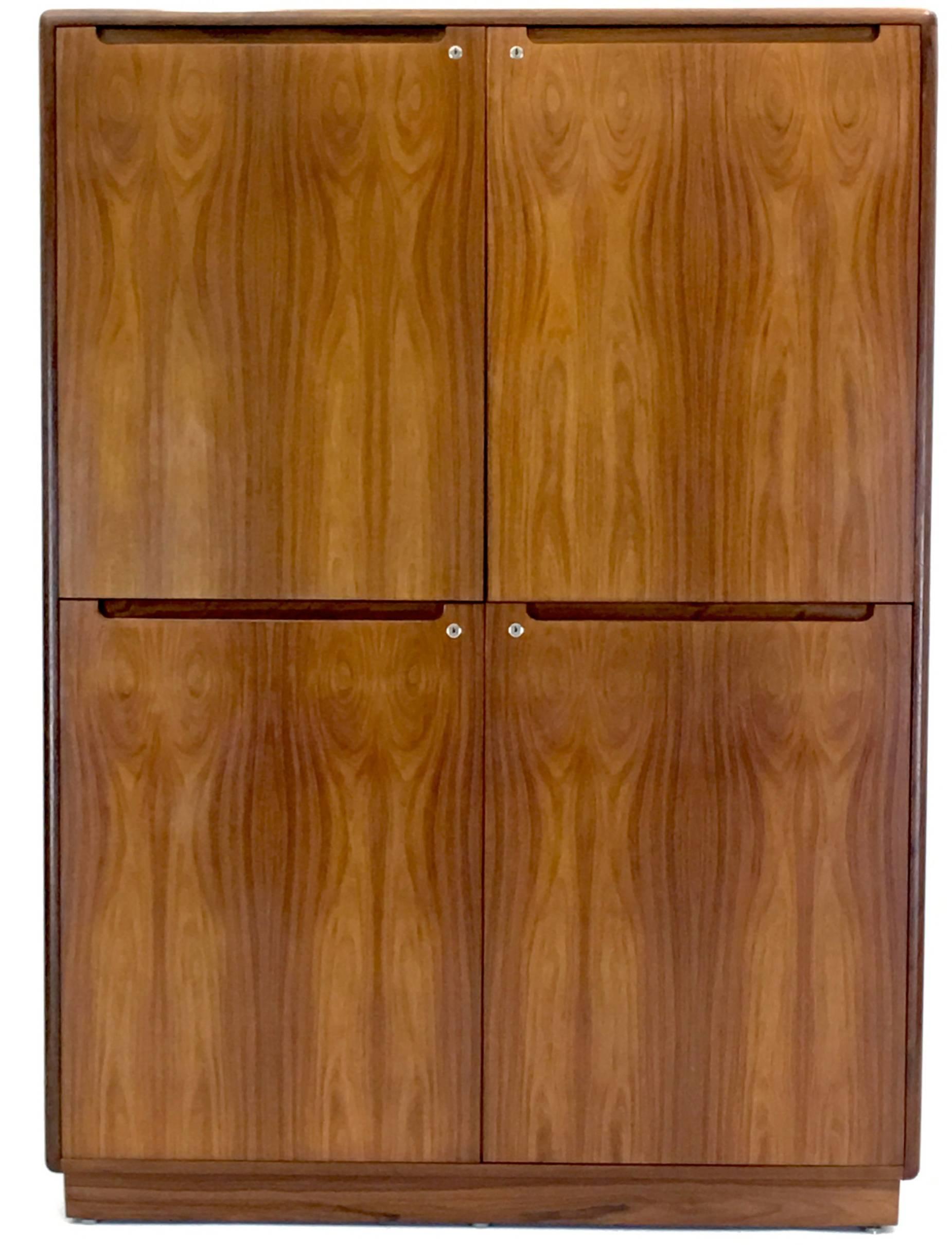 A true utilitarian cabinet by Nordisk Andels-Eksport produced in rosewood. Comes with central rosewood shelfs as well seven others that are totally adjustable in height with dozens of positions. Top doors, bottom doors or all doors can be removed