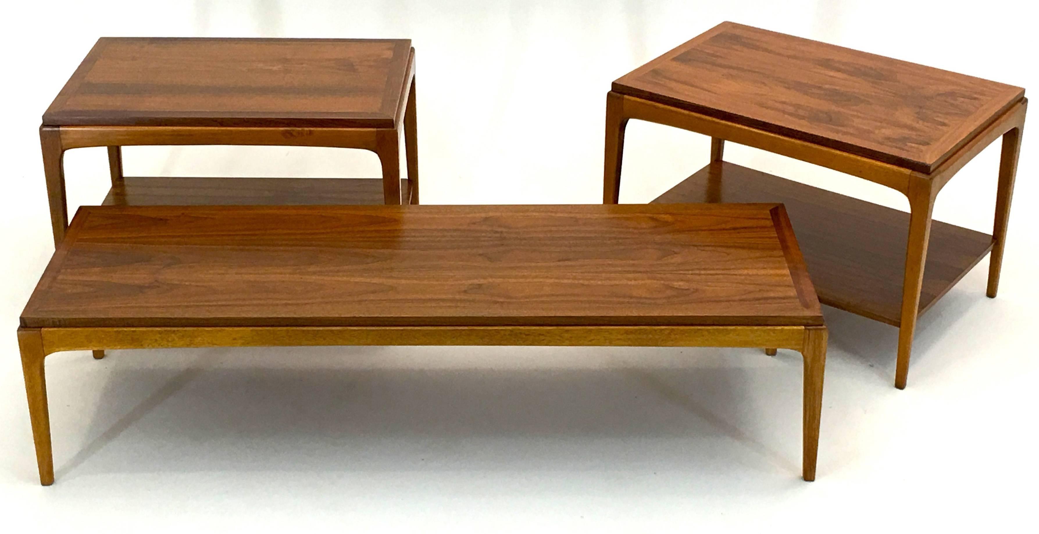 A fully complete set of Minimalist tables by Lane in premium walnut dated and signed 1966.

The two end tables are two-tier and measure 20.25" tall and 29.5" deep and 20,5" wide. The main cocktail coffee table is a low table