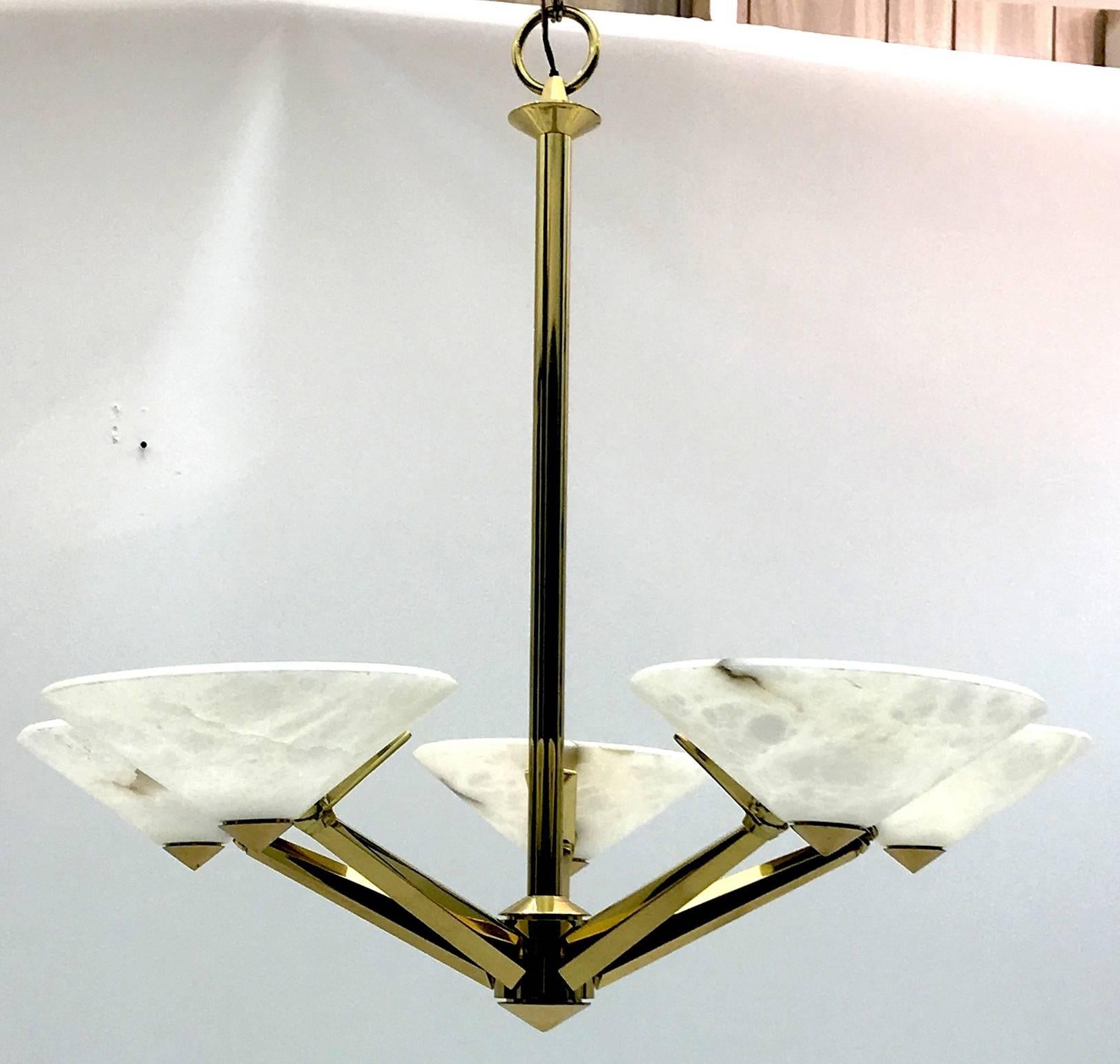 This vibrant chandelier from Lightolier not only imparts a Mid-Century modern flair; it also carries Art Deco qualities in its sunburst pattern with bevelled edges and alabaster shades rather than glass.

As with all Lightolier products quality is