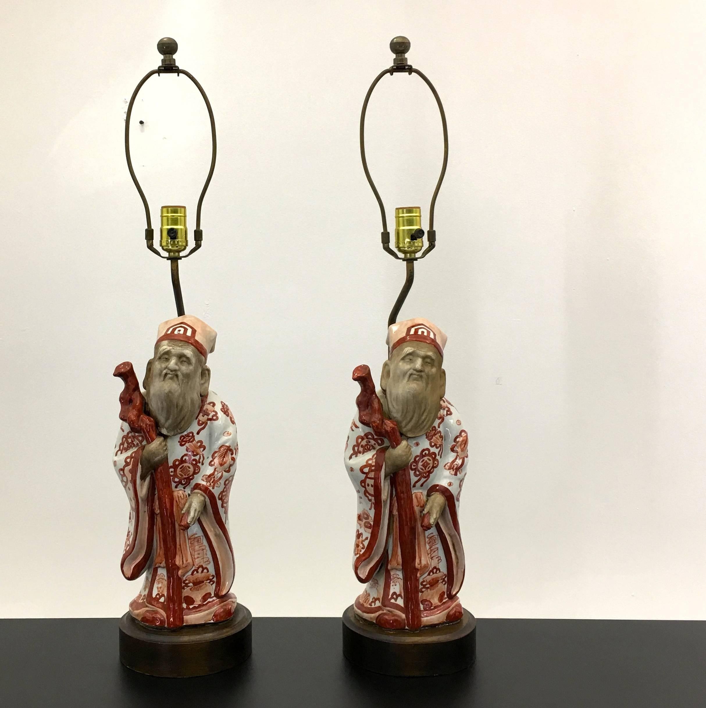 Very fine work by the lighting company Frederick Cooper of Chicago, dated to the early 1950s using hardware imported from Italy, and ceramic statues of oriental Japanese wise men produced in Japan. These statues are mounted to walnut bases with felt