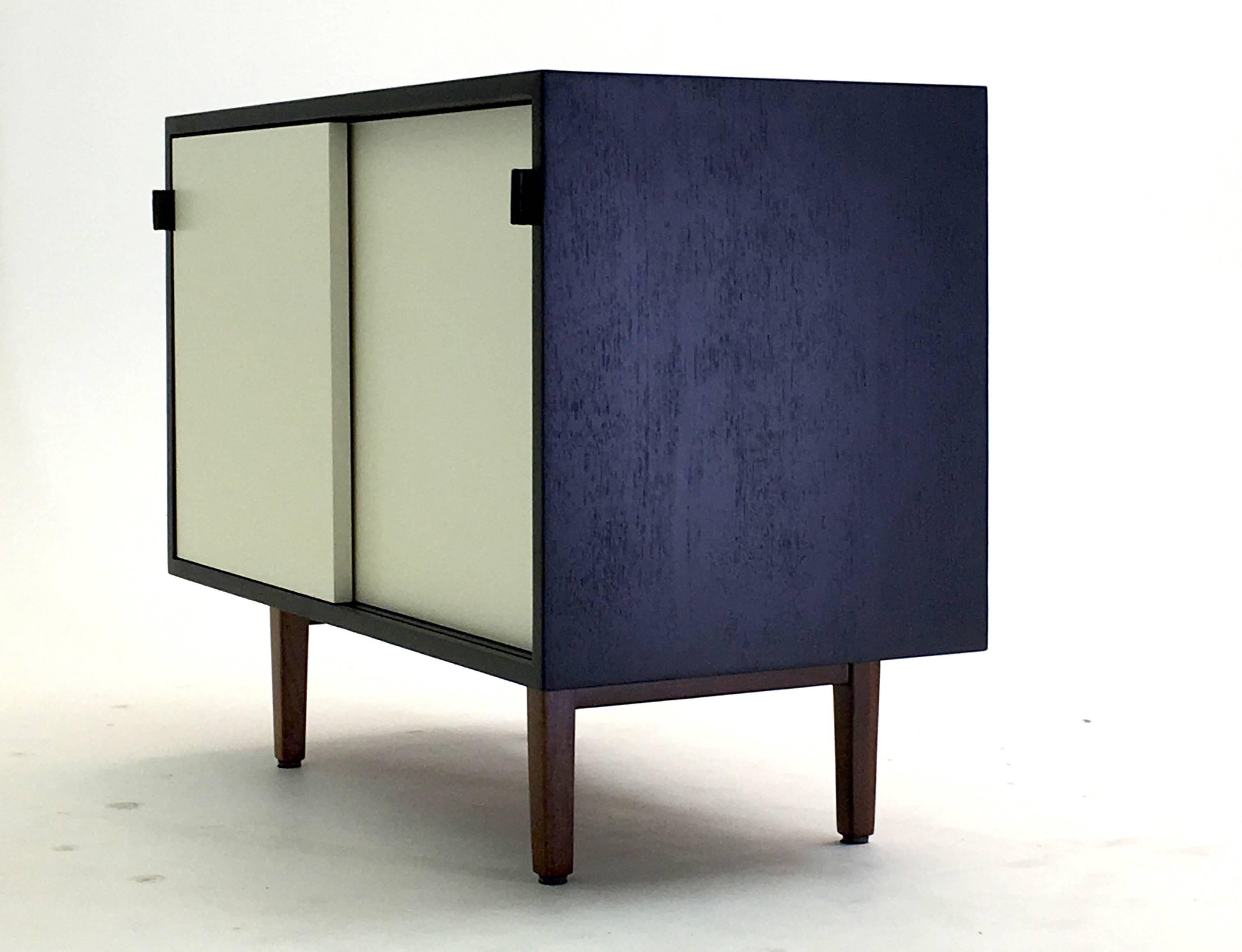 Designed by Florence Knoll and produced, circa 1952, this exquisite cabinet features the sculpted walnut wood legs performed only on the earlier designs in the 1950s and is signed underneath with the Knoll Associates label.

Measures 28"