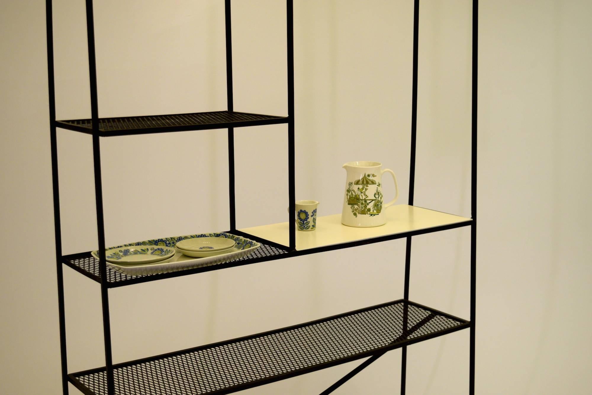 Exceptionally multifunctional shelving unit by Freda Diamond that can be used as a room divider, etagere or bookcase for dining, living or even patio use with outdoor furniture. This versatile display unit is constructed of steel mesh on wrought