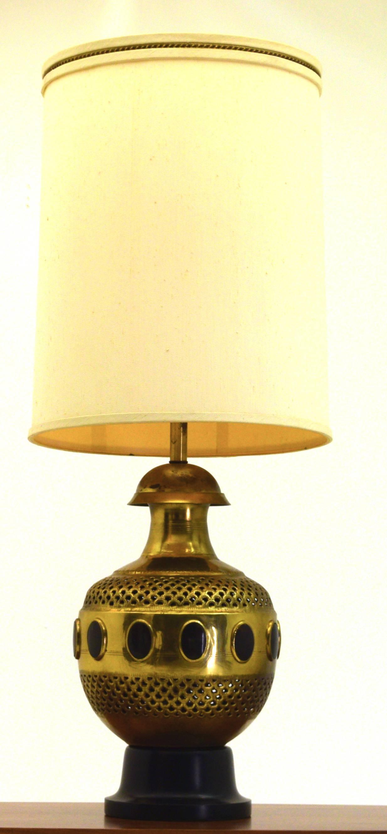 A very large table lamp likely produced by Feldman Lighting, with the work being completed in Europe and imported. Certainly a Moroccan in style and dated to circa 1955. 

Lamp with shade measures 17.5
