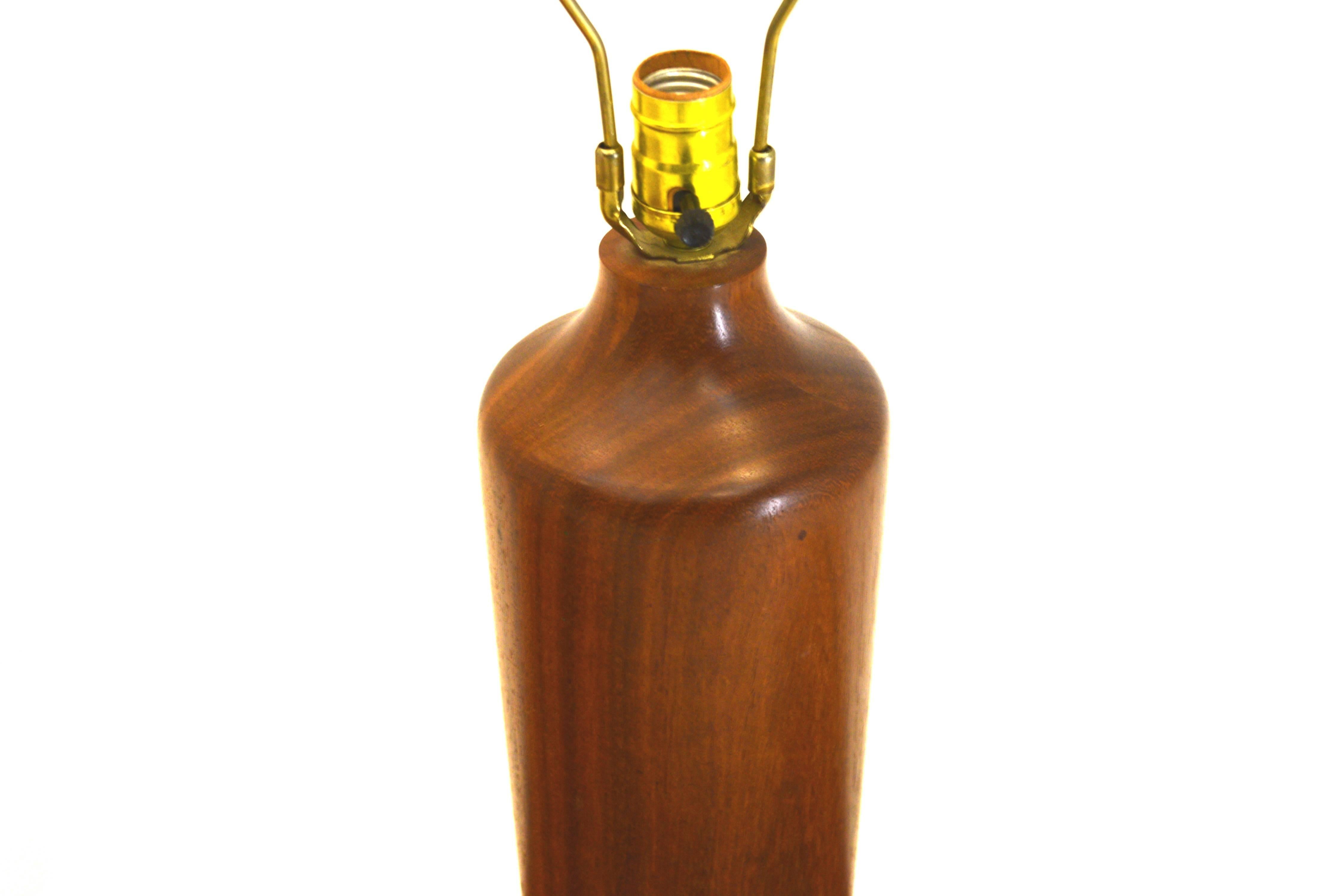 Table lamp,teak, circa 1965
Measures: 5 wide x 23 inches to finial. Body is 15 inches tall.
Very heavy, with perfect proportions. The light switch is located at the 16