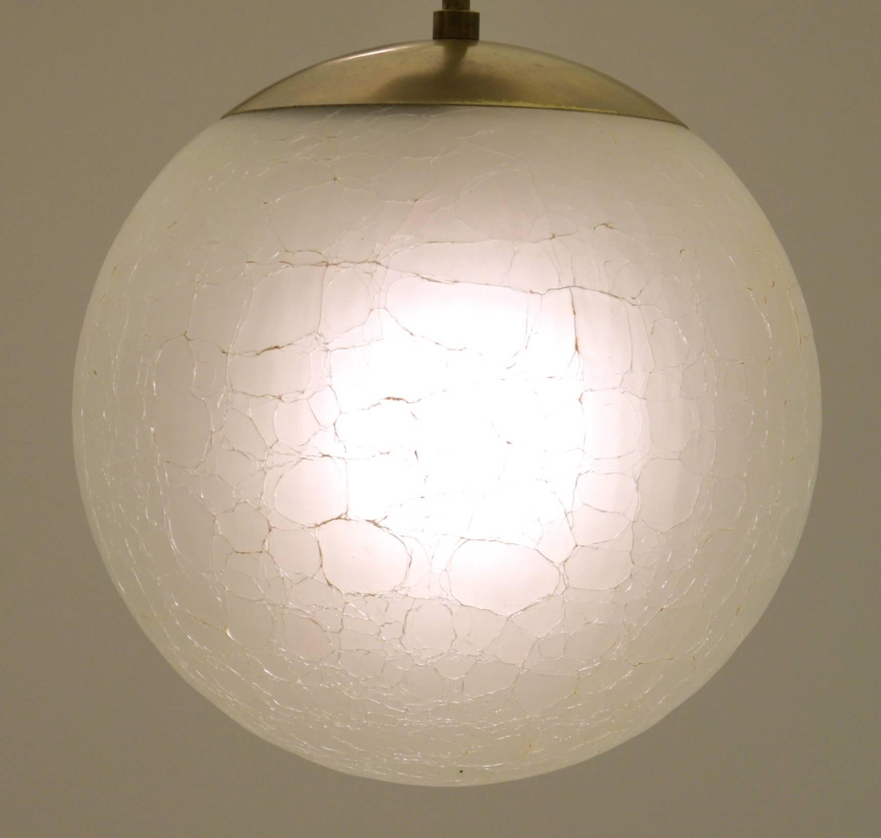 A unique heavy crackled glass produced in Italy for Moe and assembled in the USA, this pendant lamp is a fine example of italian glass workmanship and American brass manufacturing for the components. The stem has a solid brass pivot meaning the