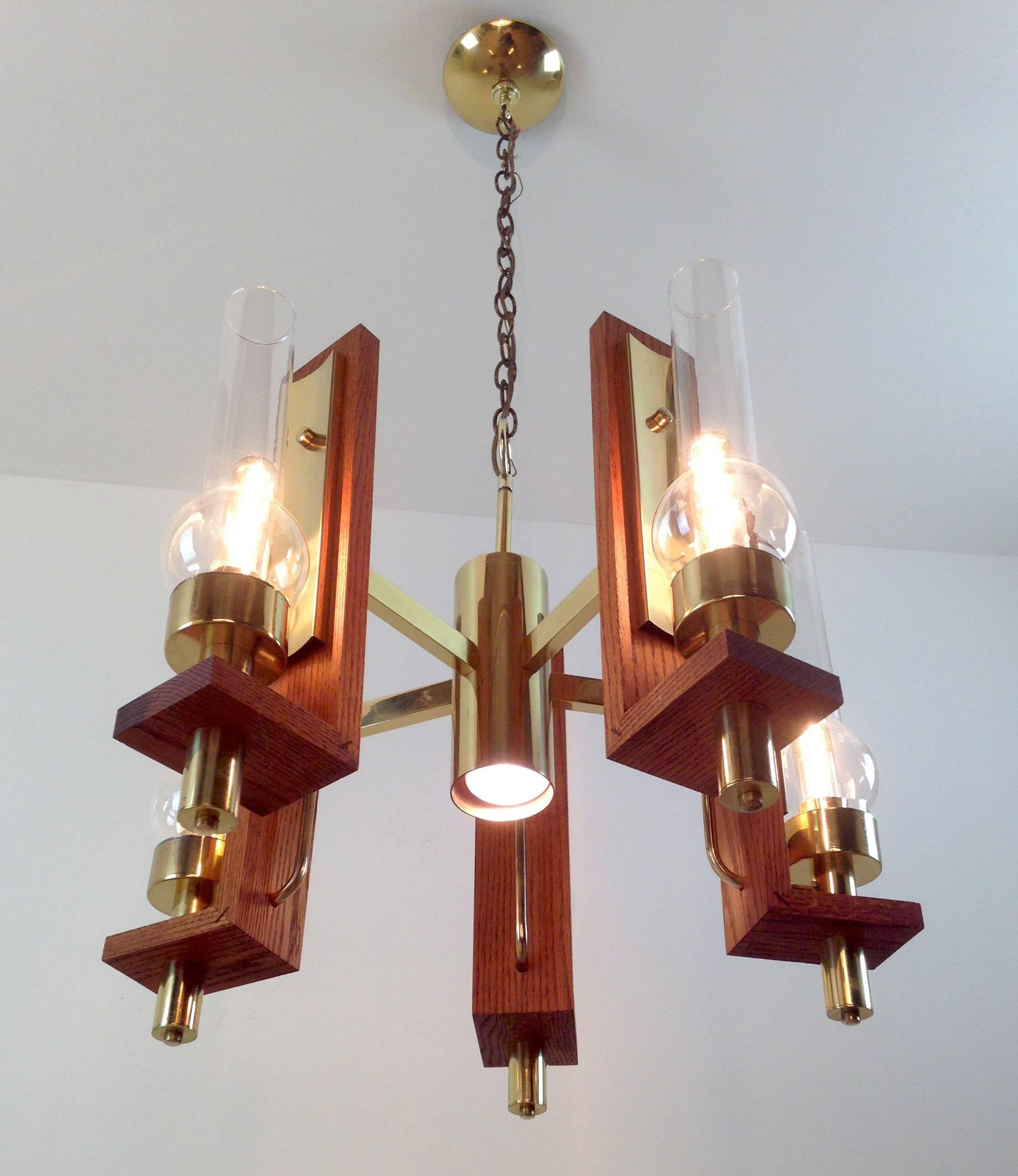 This signed Vintage Sonneman chandelier was created circa 1960 and represents his early work in the lamp industry.

This lamp is constructed of solid plate brass, red oak and glass and weighs over 40 pounds. The total height is 42" though this