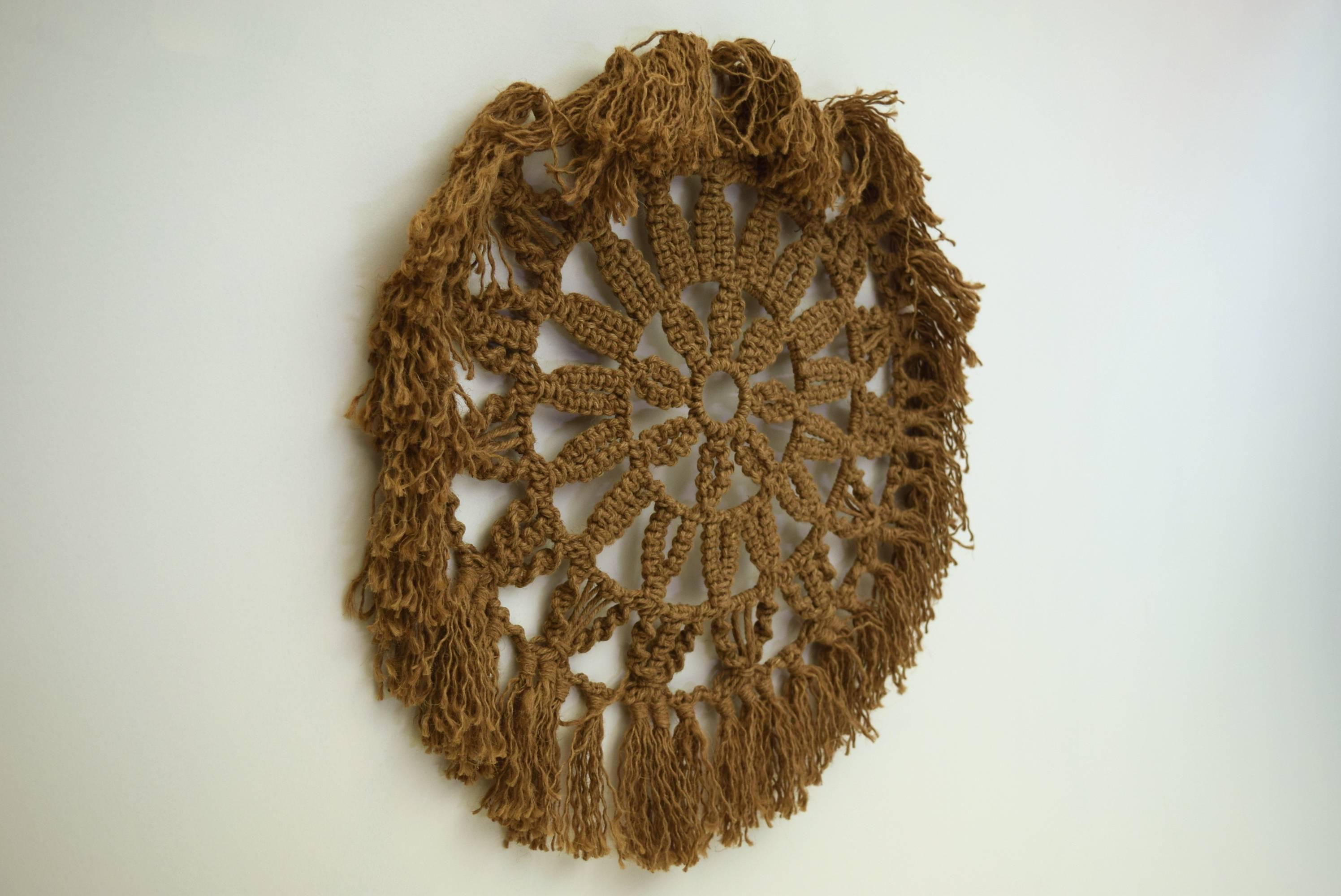 Popular 1970s item, these wall hanging were produced in various sizes with this model being about as large as they got at 3 feet in diameter.

Produced using rings of steel that are then hand woven over, these mid century modern textile wall art