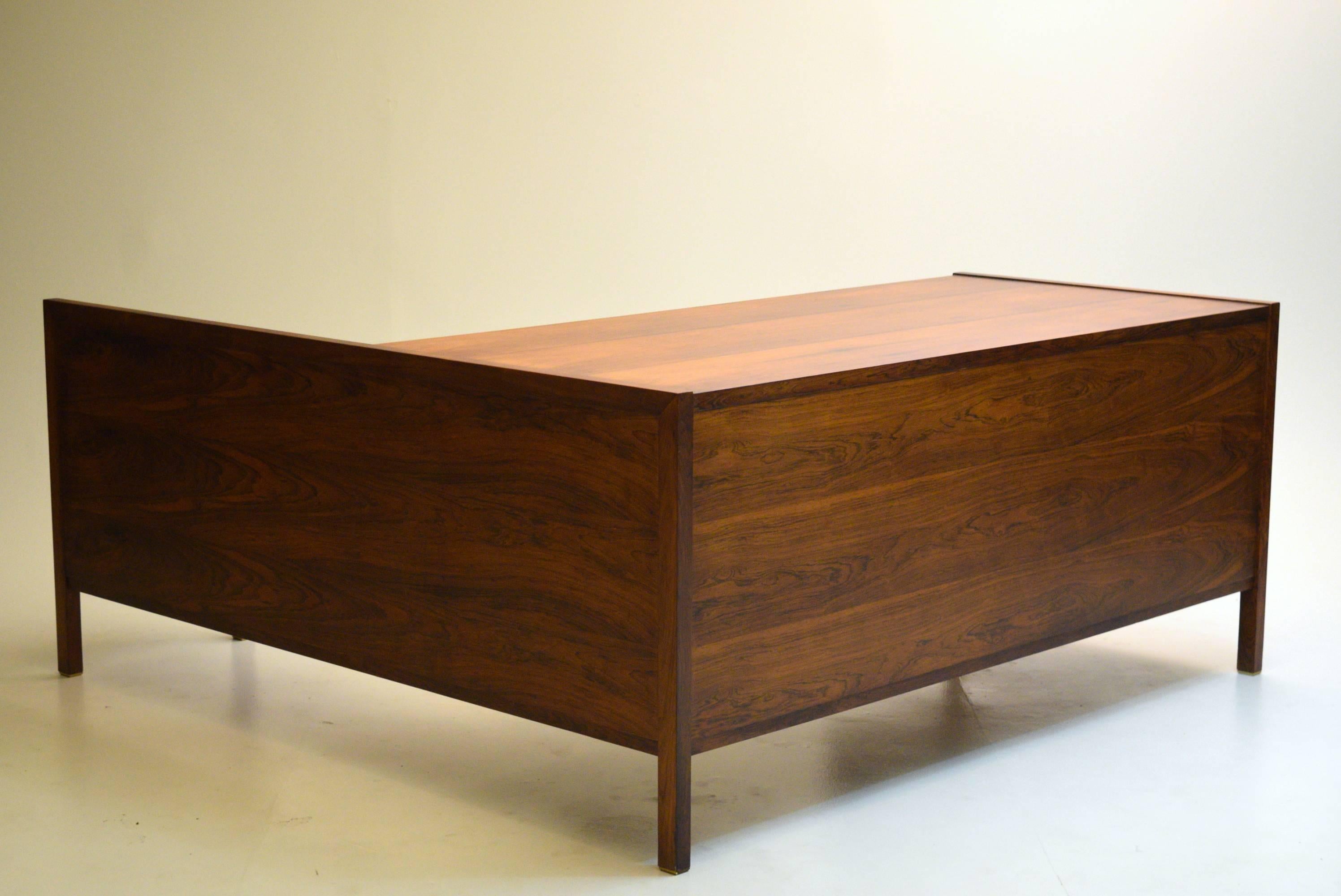 A rare all-rosewood desk with return built in by Dunbar, designed by Edward Wormley. Normally rosewood is used as a highlight feature on desks, whereas here we see a decadent use of the material over the entire piece, to the undersides and invisible