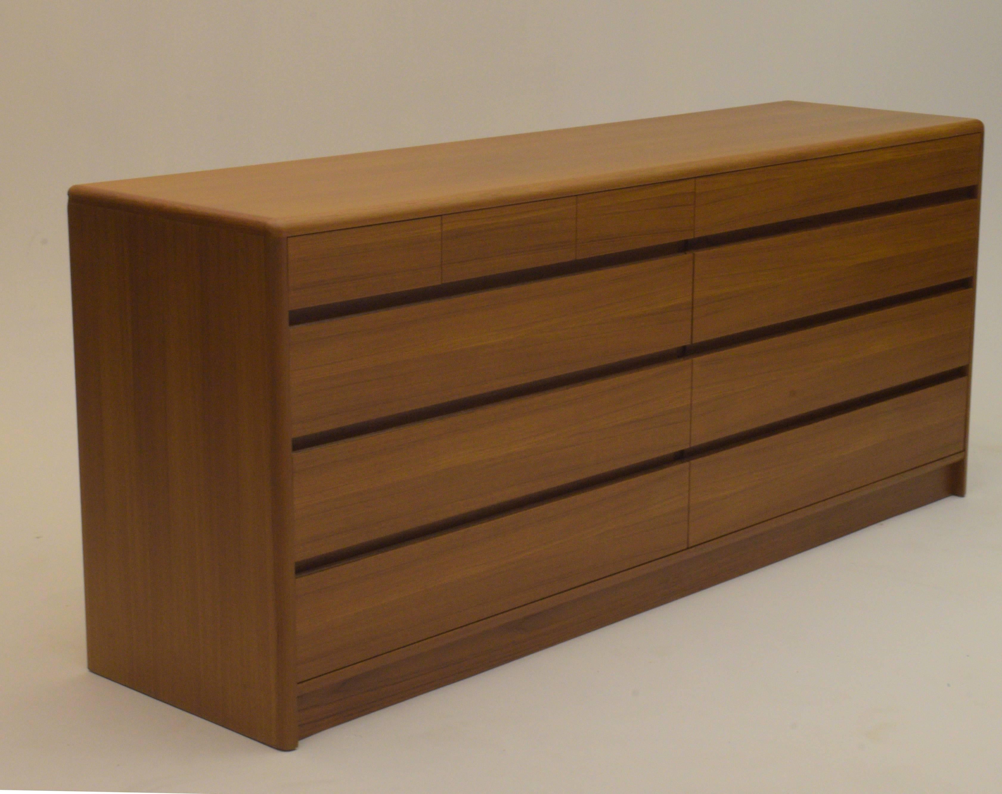 Long, low sleek Danish modern design for your bedroom or living space as a credenza. Produced in the 1960s Copenhagen, Denmark. Stunning quality with book matched teak and exceptionally well built.

Matching tall boy chest (armoire) available in