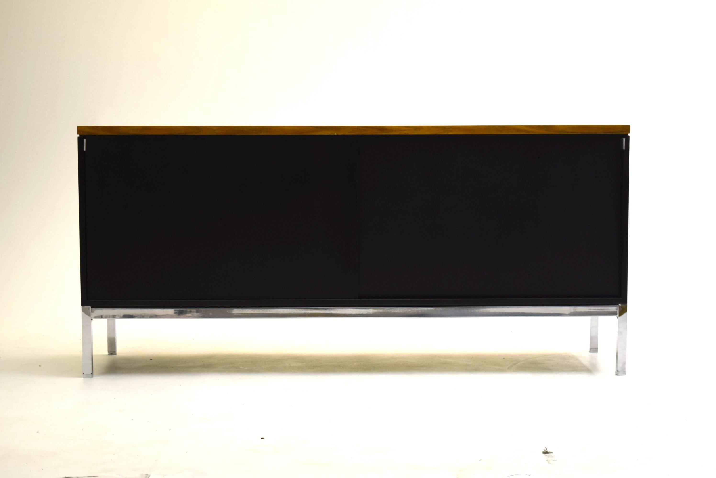 By Florence Knoll, produced circa 1959-1965. 

Measures: 27.5" tall, 60" wide and 18" deep. Fully finished on all sides for placement anywhere.

This credenza contains two adjustable shelves, two file drawers and two pencil