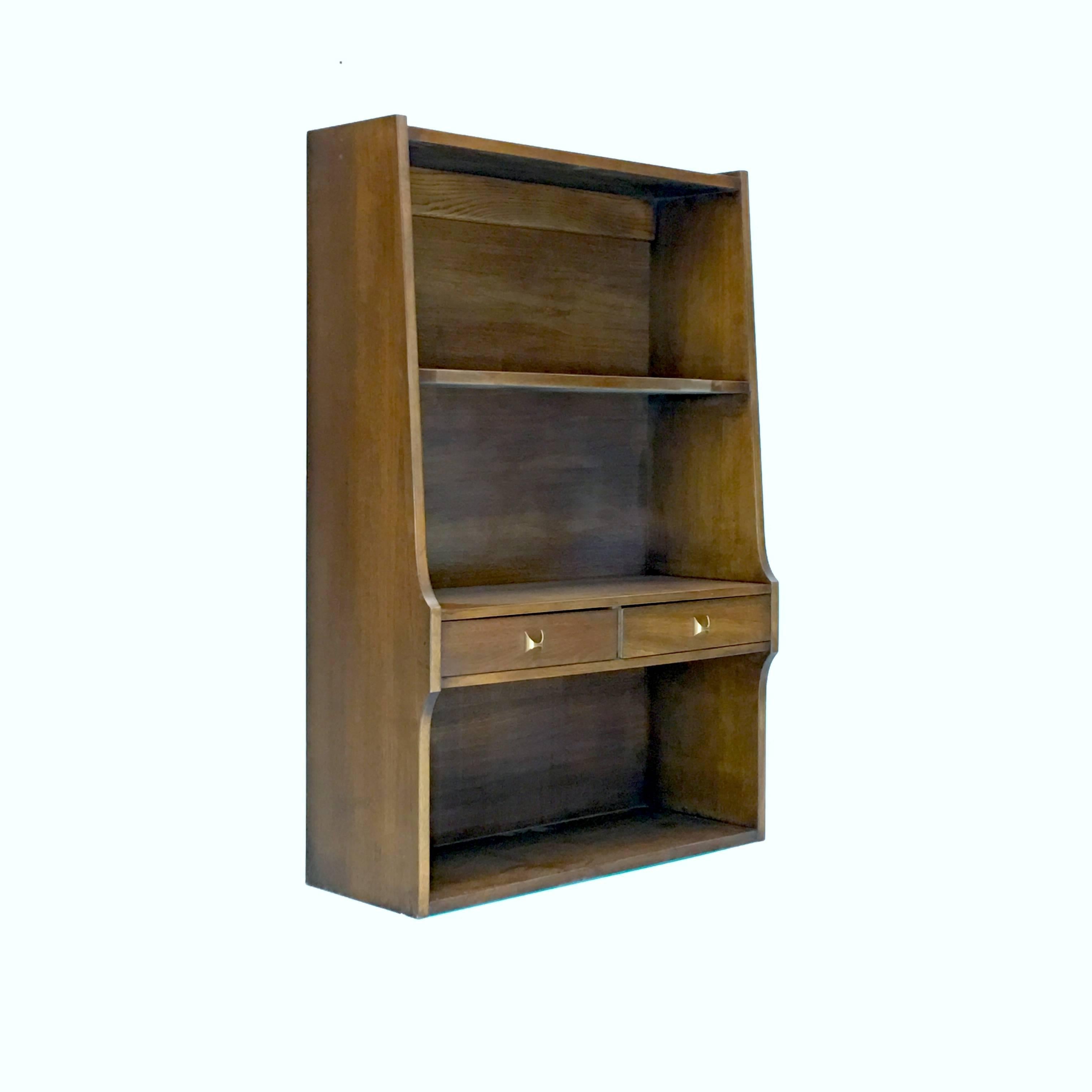 A hard to find cabinet and shelf unit from the Broyhill Brasilia Premier line which was inspired by Oscar Niemeyer's Mid-Century architectural marvels in Brazil. 

Listed in the original Brasilia catalog under occasional furniture. This is a