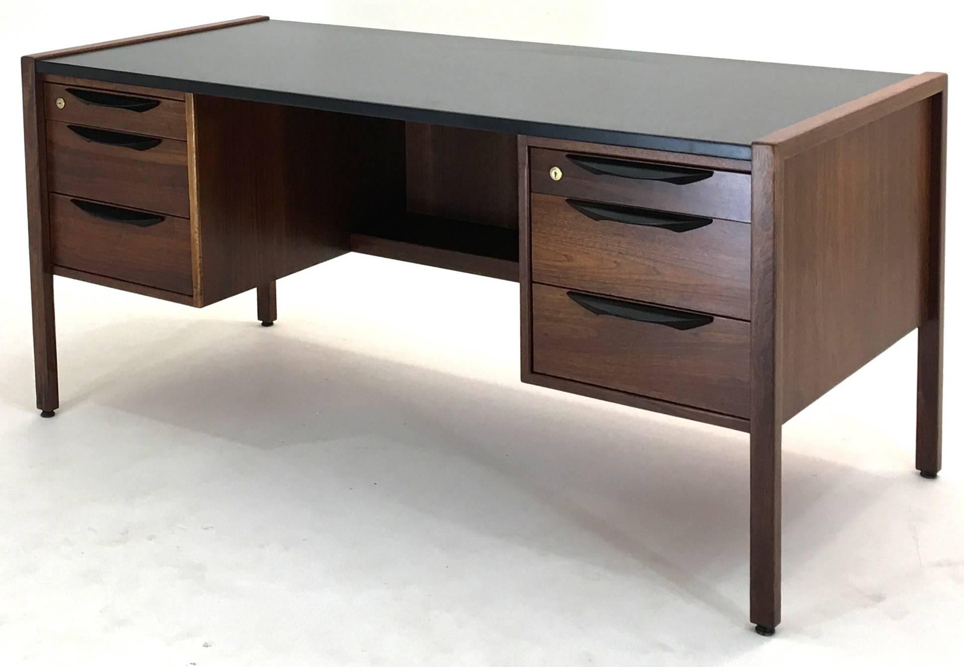This listing is for the desk and chair pictured. Sharp. Crisp, sophisticated and elegant this executive Desk by Jens Risom was produced in the mid-1950s with exceptional construction and a distinctive look to the dark American black walnut imparting