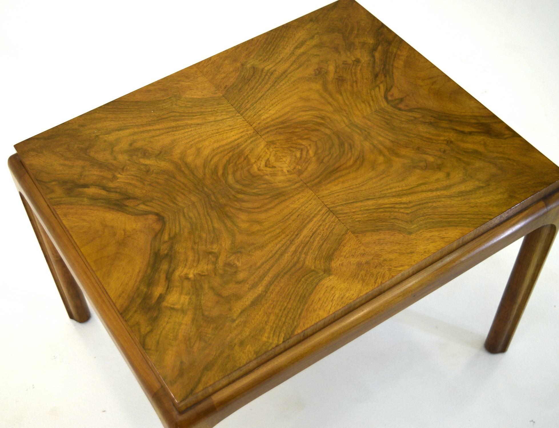 A versatile small coffee table by John Widdicomb in bookmatched burl on the top with finely crafted legs. The table top is raised giving a plinth style appearance. 

Measures: 22" x 18" and 16.25" tall.

Note the legs and