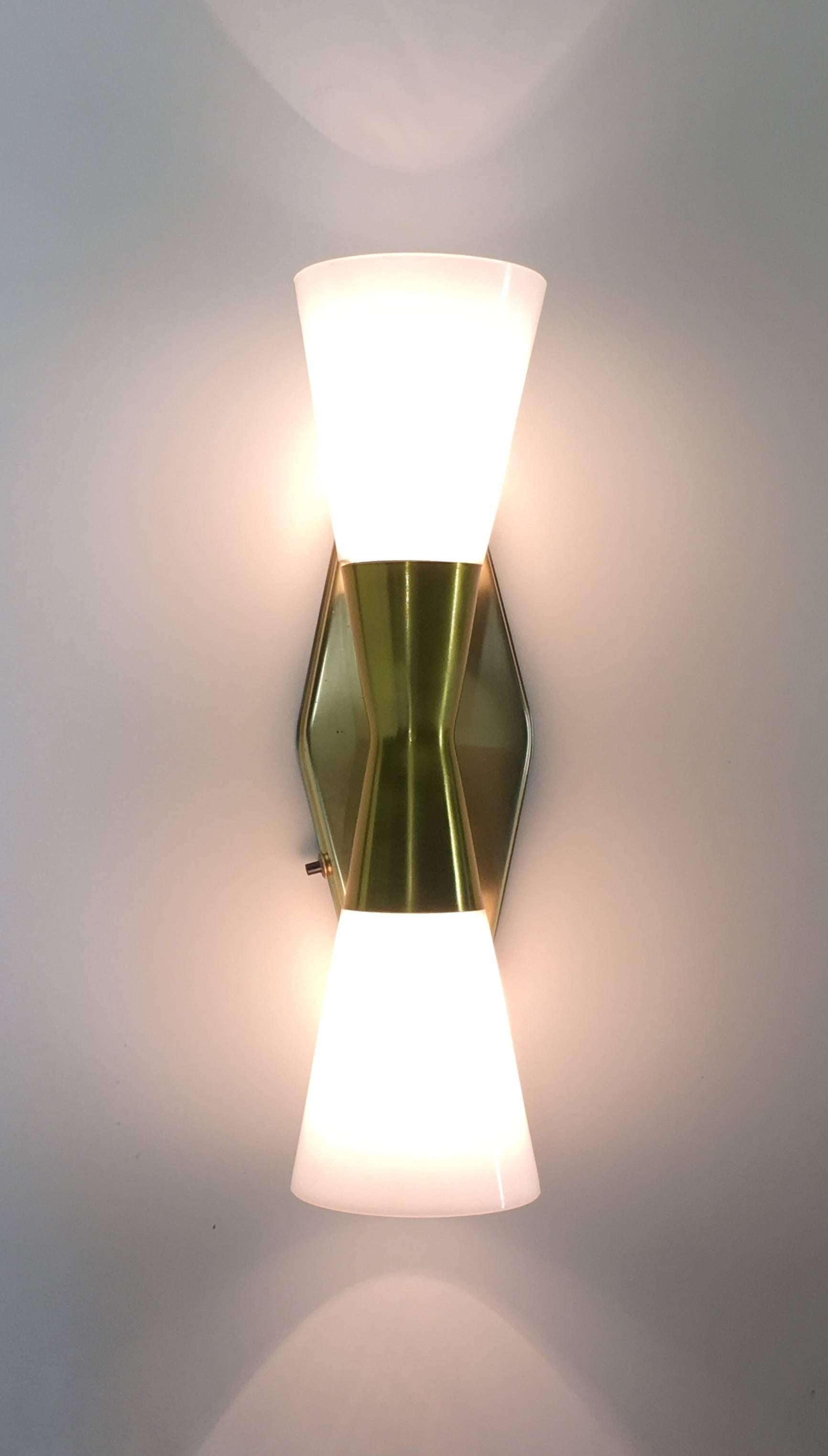 John Virden,
Virden lighting
circa 1950, USA
Pair of sconces
Measure: 16.5 tall 6.25 inch wide

The bow tie sconce model V-6446 lamp produced by John C. Virden Lighting in the 1950s became iconic and has been reinvented many times, though none